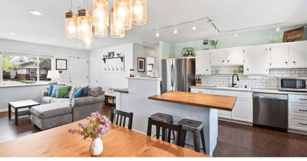 kitchen remodel with island bar, beautiful lighting, & an open concept.
