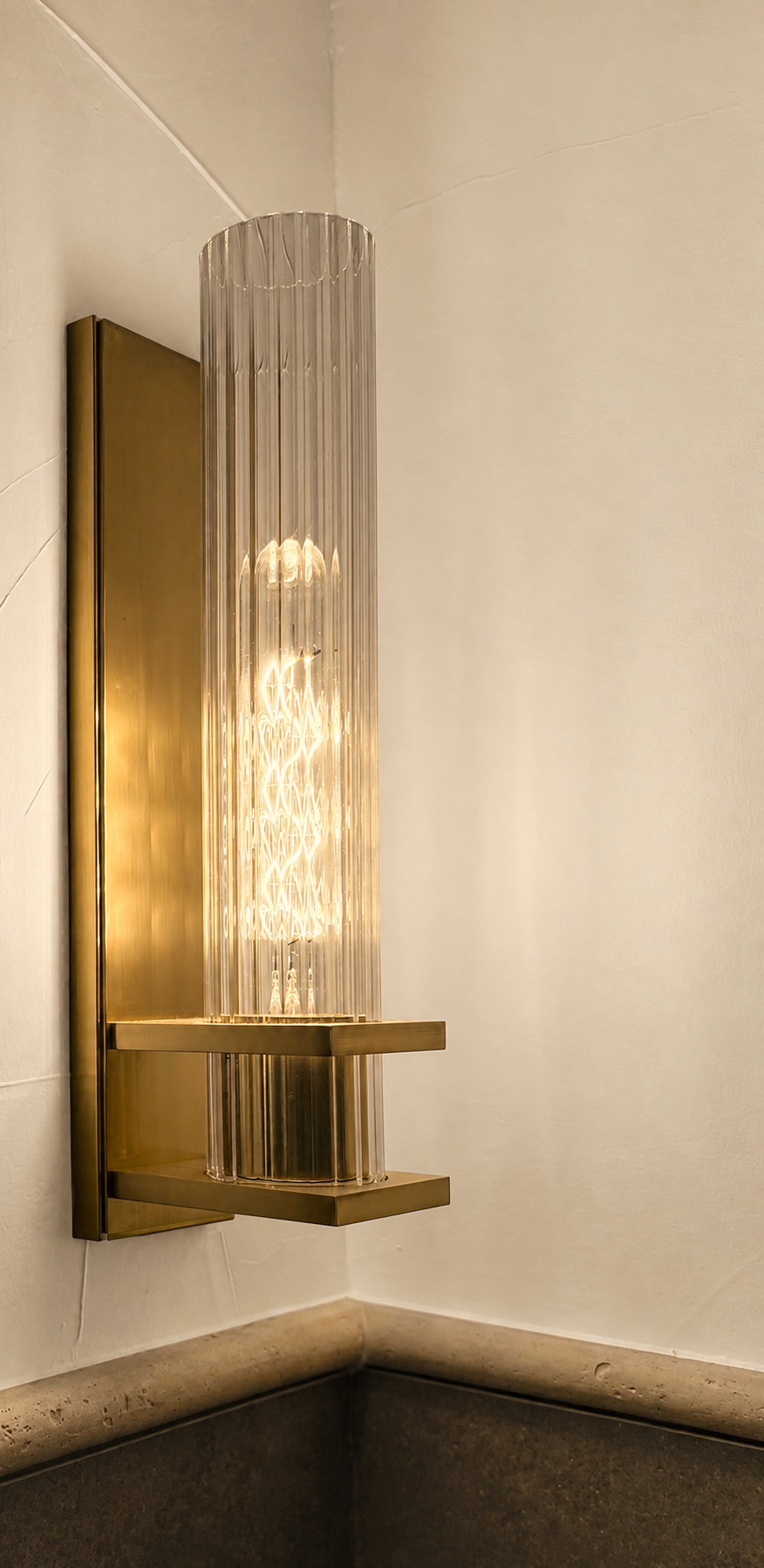 brass and glass wall sconce detail in littleton co kitchen and bathroom remodel