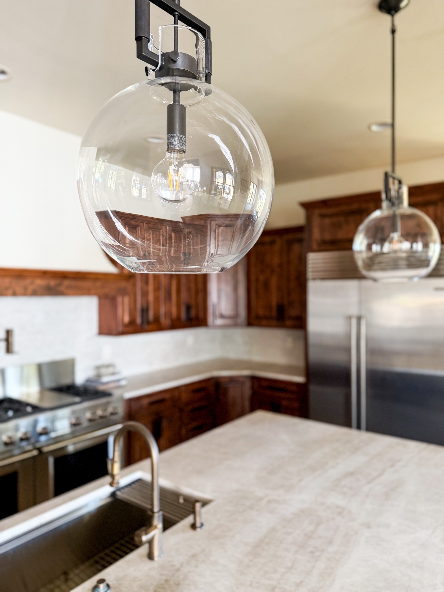 clear glass globe pendant light above kitchen island in littleton co kitchen remodel