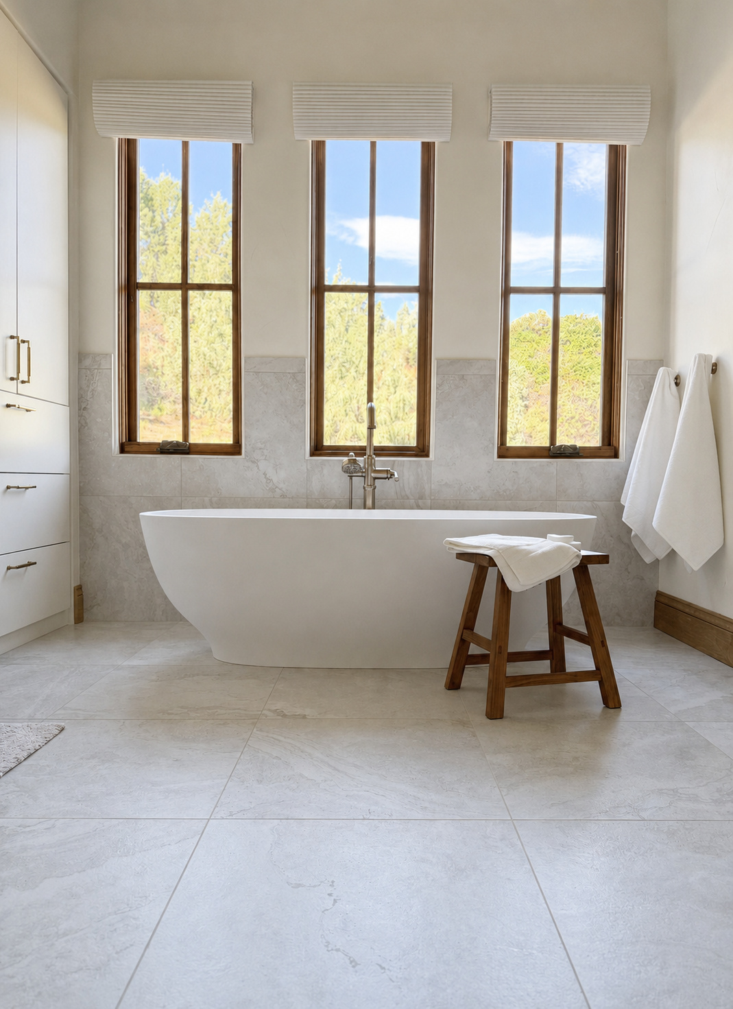 freestanding soaking tub beneath three windows in littleton co kitchen and bathroom remodel