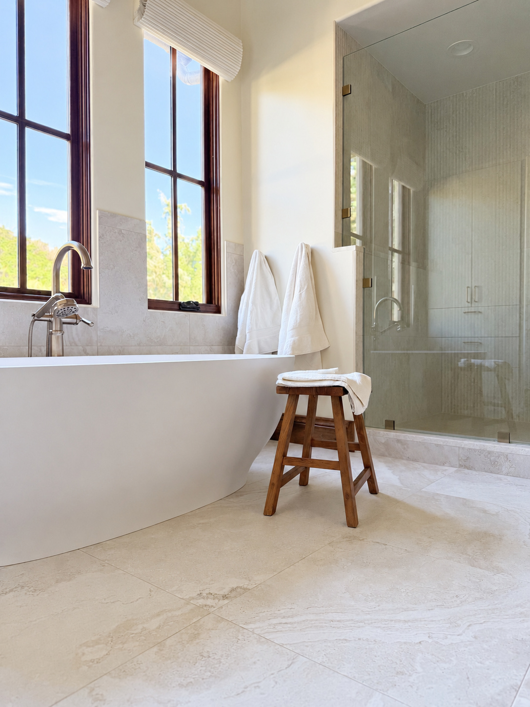 freestanding tub beside glass shower and tall windows in littleton co kitchen and bathroom remodel