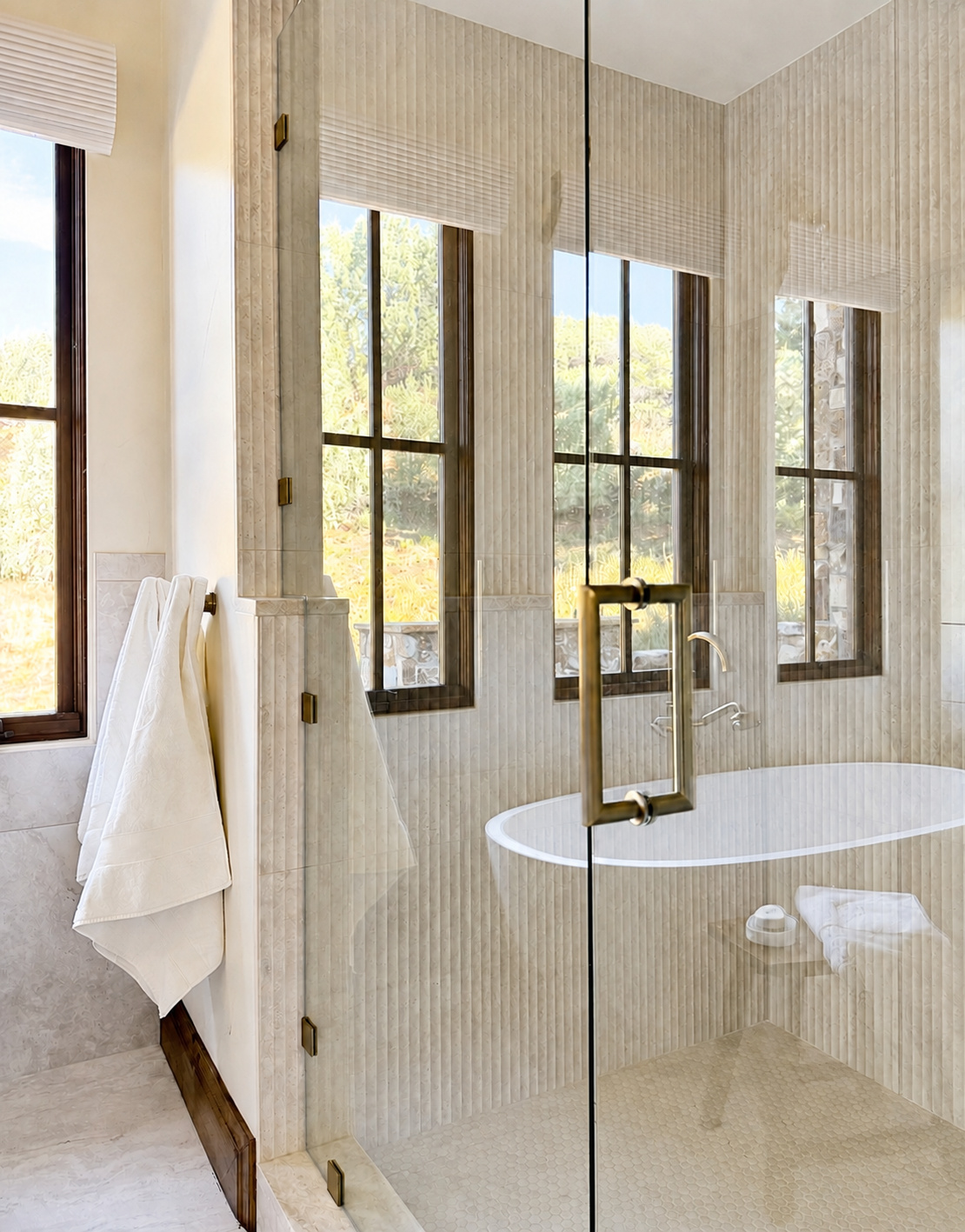 glass enclosed shower with fluted tile and brass hardware in littleton co kitchen and bathroom remodel
