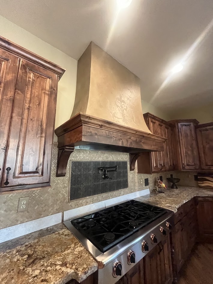 littleton co kitchen and bathroom remodel before gas range with custom wood hood pot filler and rustic cabinetry