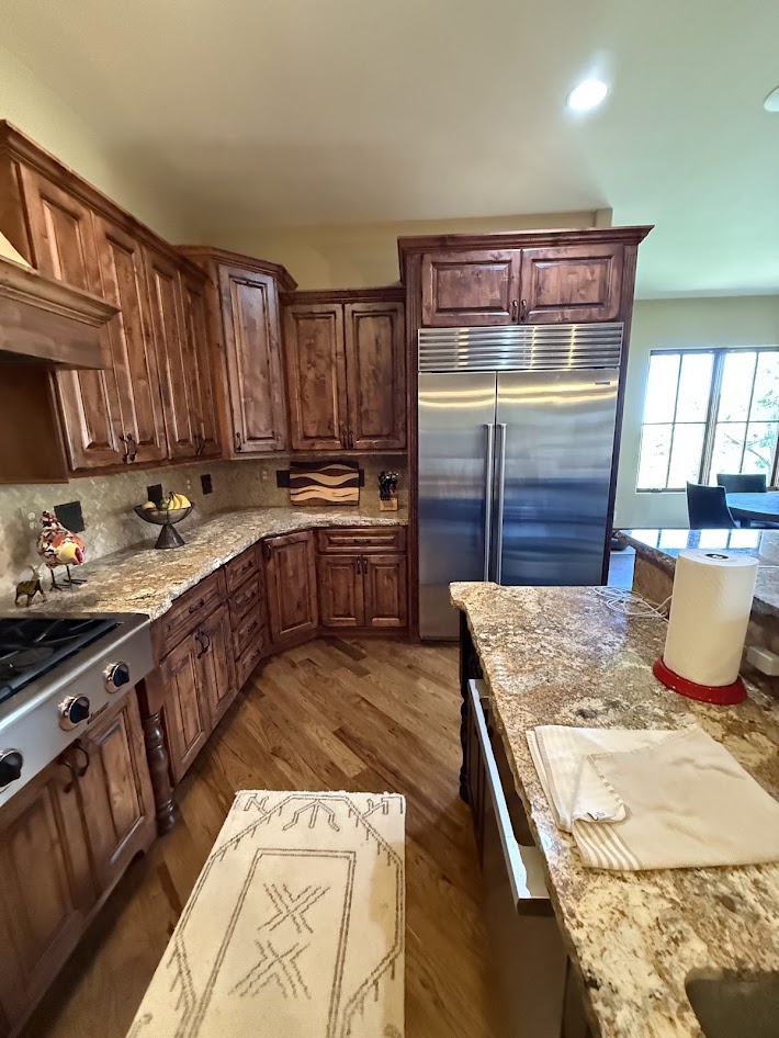 littleton co kitchen and bathroom remodel before view with wood cabinetry stainless steel refrigerator and granite counters