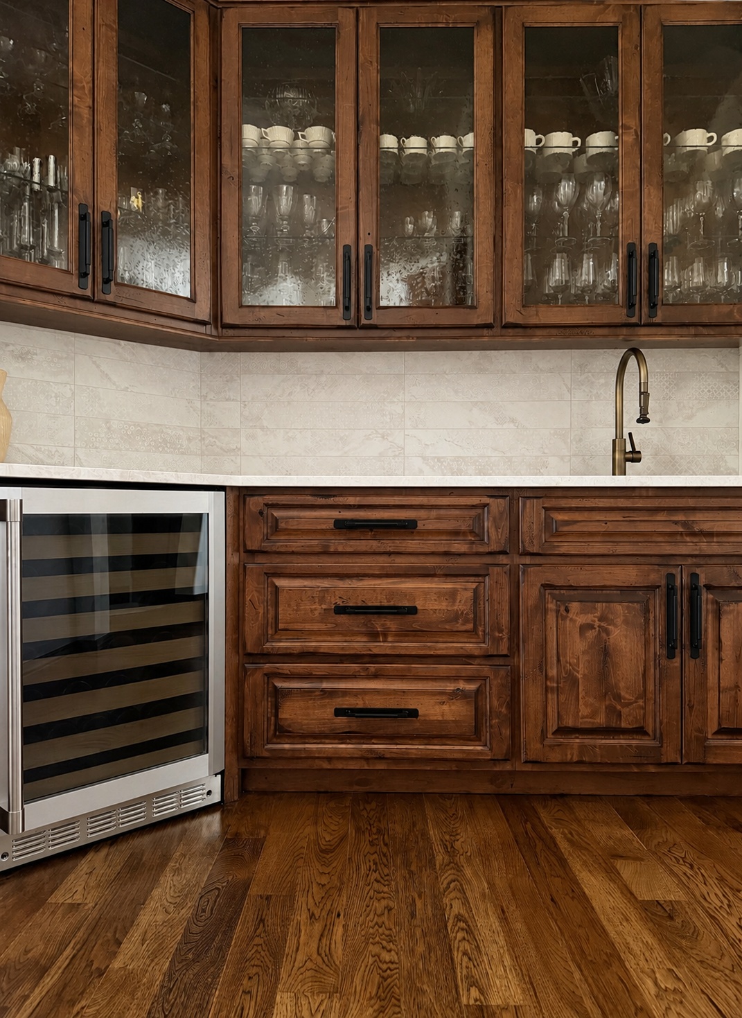 rustic wood kitchen cabinetry with glass doors and wine refrigerator in littleton co kitchen and bathroom remodel