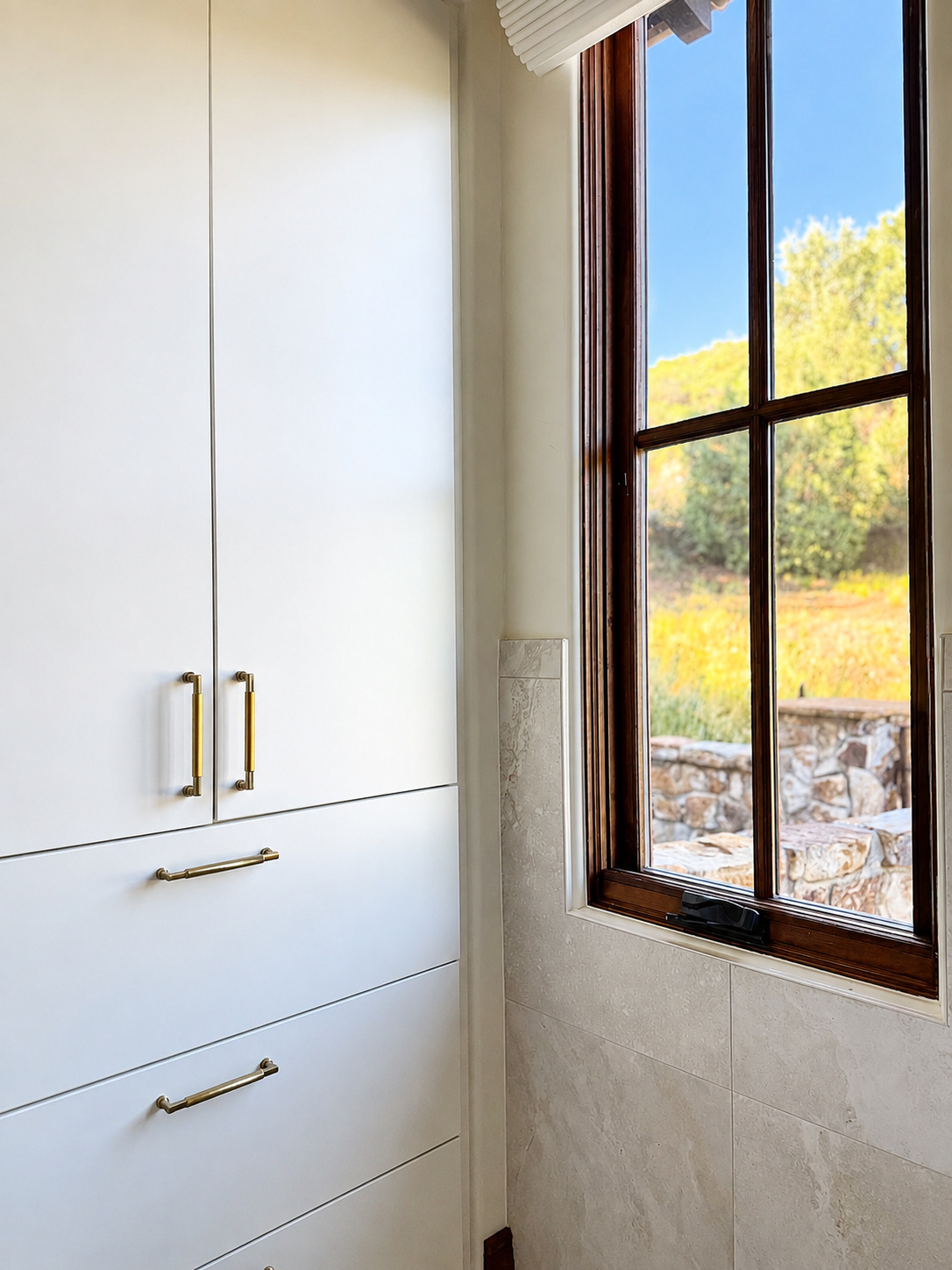 white built in bathroom storage beside wood framed window in littleton co kitchen and bathroom remodel