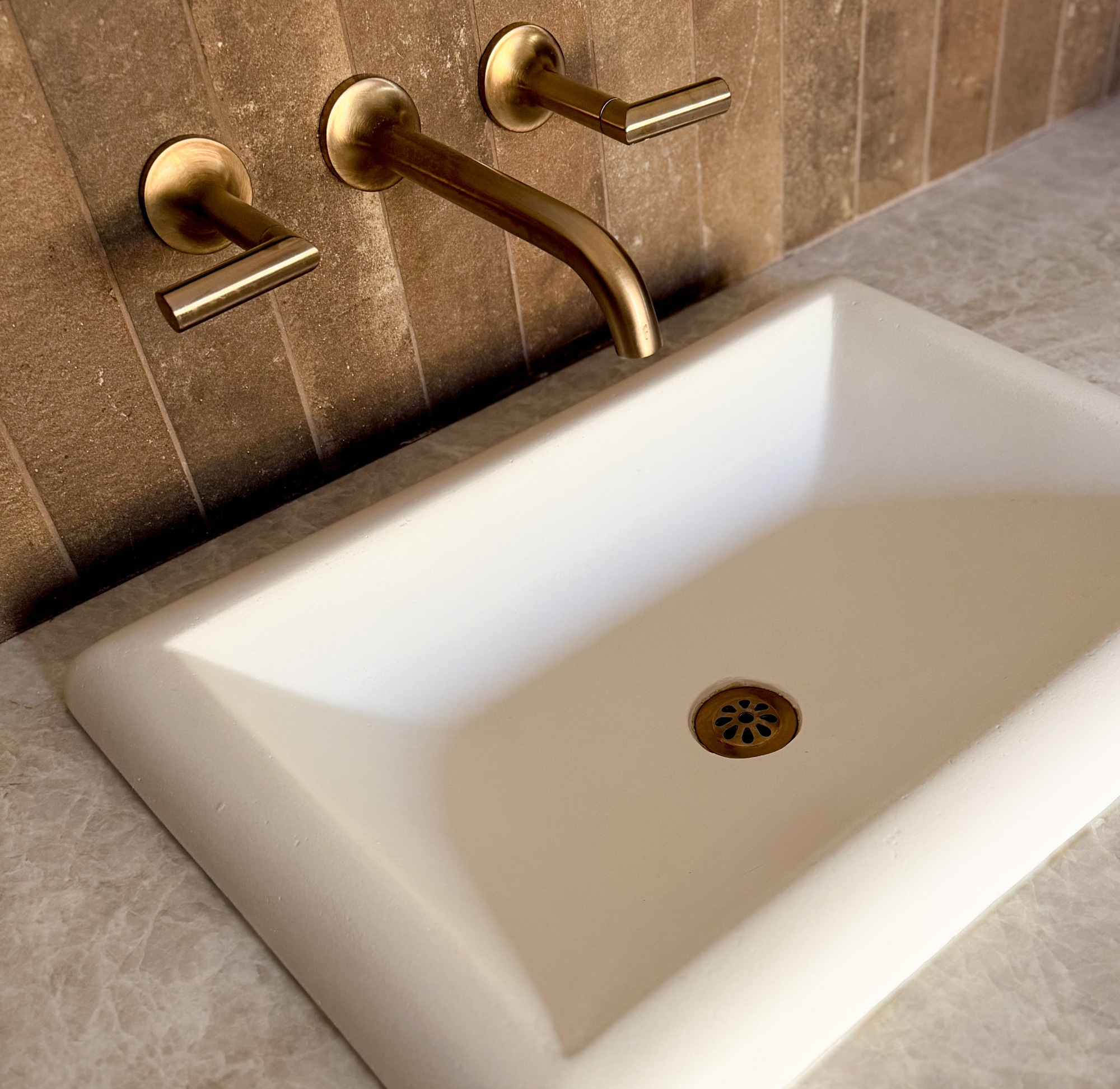 white vessel sink with wall mounted brass faucet in littleton co kitchen and bathroom remodel
