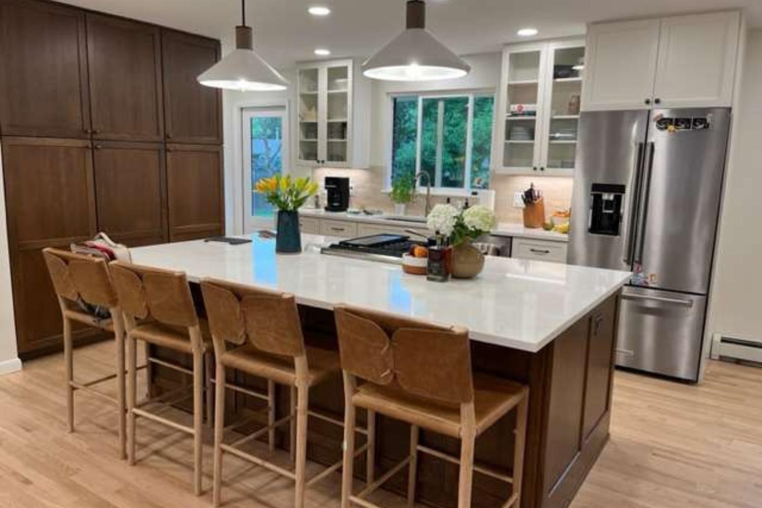 Gleaming island with chairs in kitchen remodel in Denver