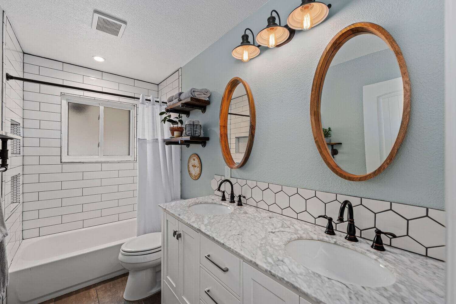 Light-white-bathroom-circular-mirrors-stone-vanitytop-Littleton-Colorado