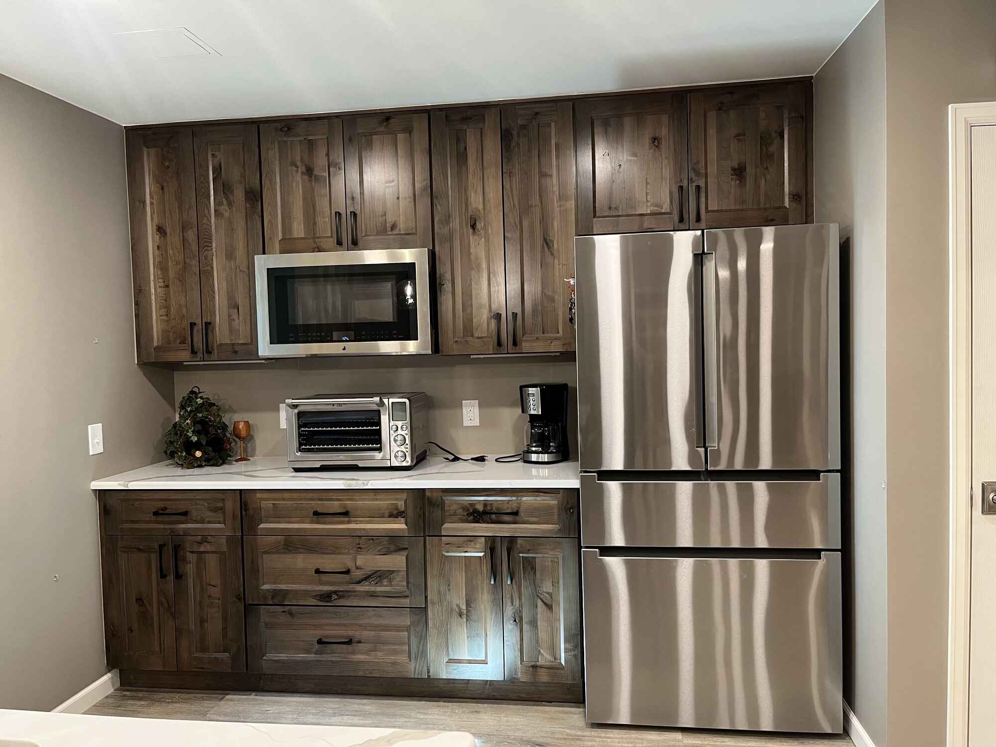 Beautiful-open-basement-kitchen-brown-cabinets-quartz-countertops-Littleton-Colorado5