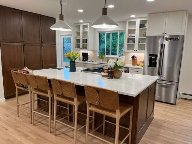 Open-kitchen-dark-cabinets-stone-countertop-brown-chairs-Littleton-Colorado