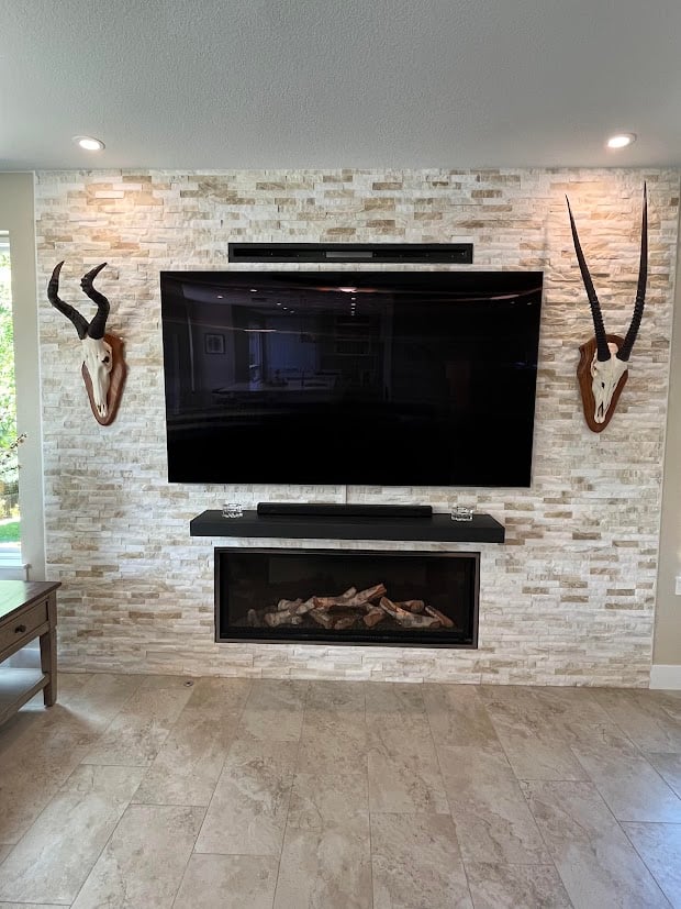 Tv with brick wall behind in living room remodel