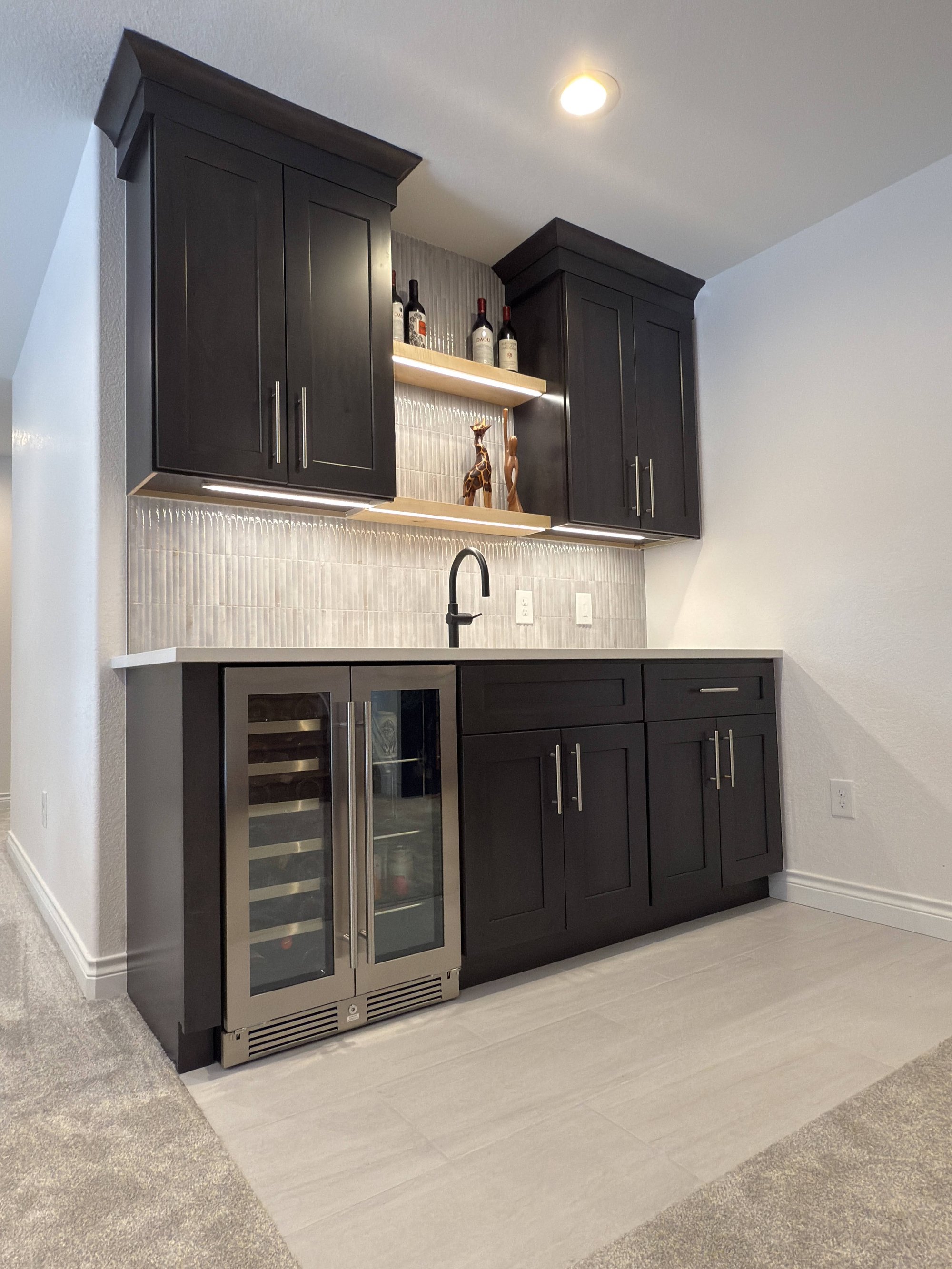 after basement remodel built in basement workspace with custom cabinetry in littleton