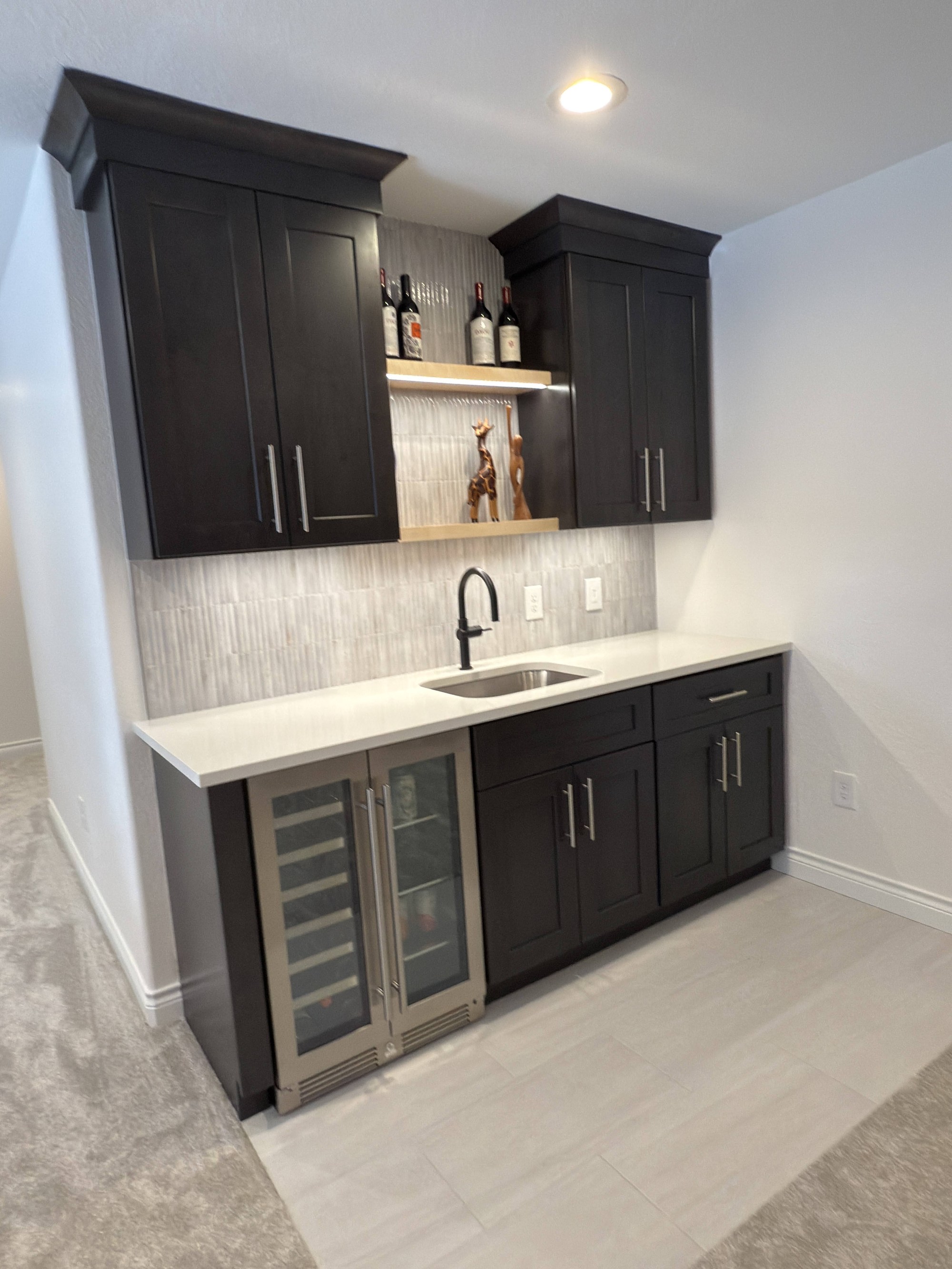 after basement remodel custom beverage station with floating shelves in littleton