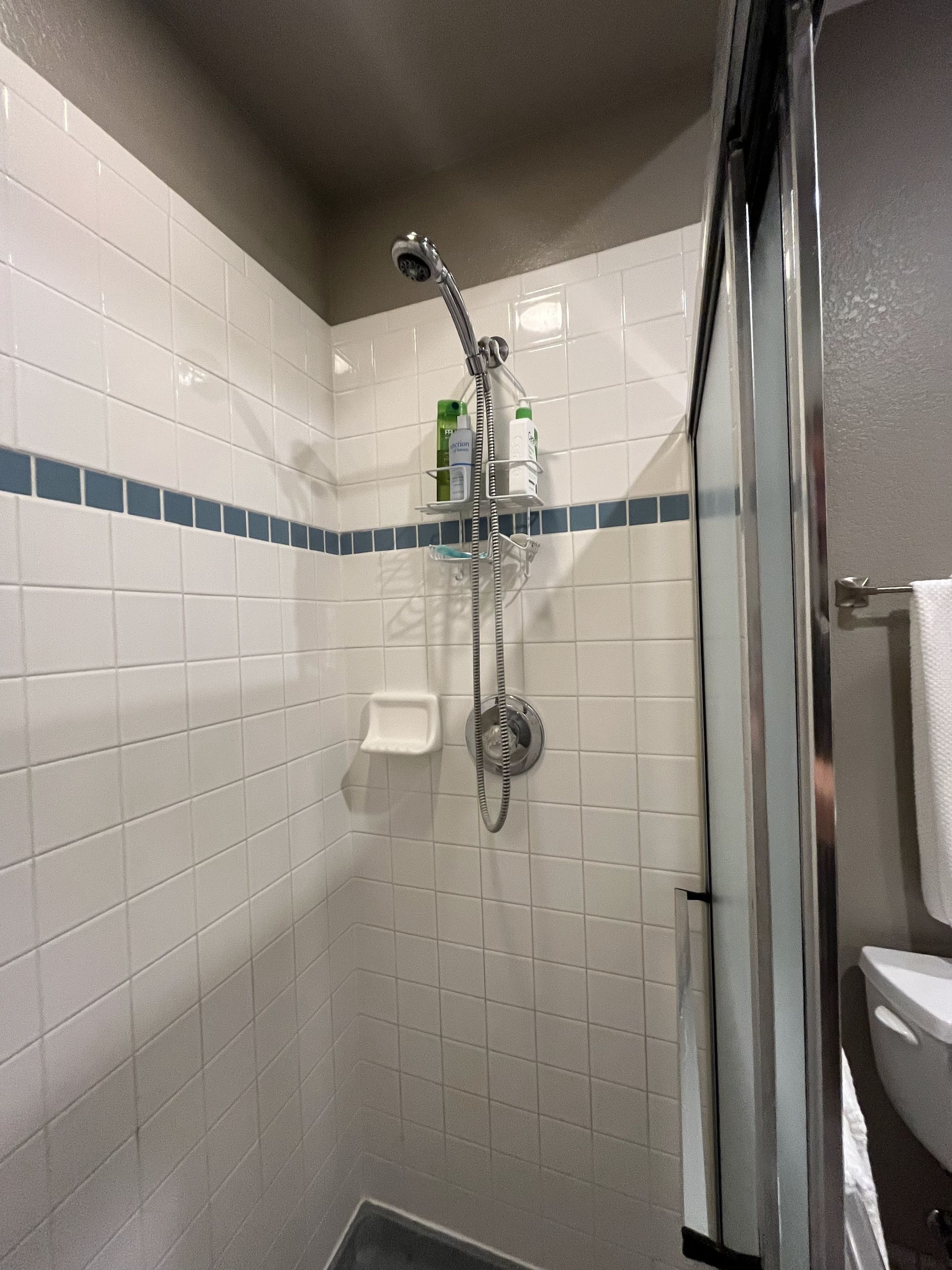 before basement remodel compact shower stall with white tile walls in littleton