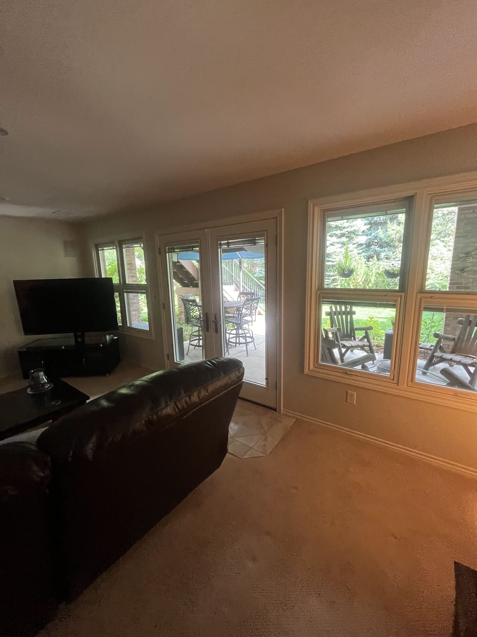 before basement remodel dark basement family room with patio doors in littleton