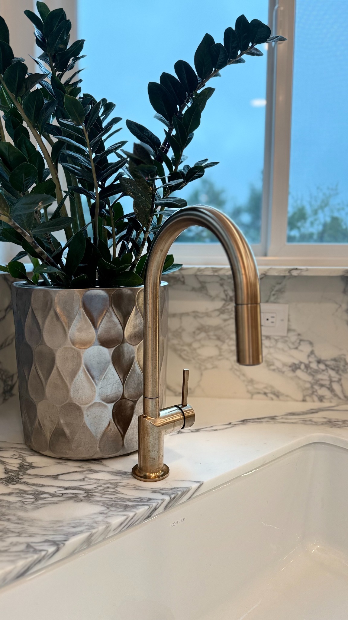 after-kitchen-remodel-with-brushed-gold-faucet-and-marble-sink-surround-in-castle-pines