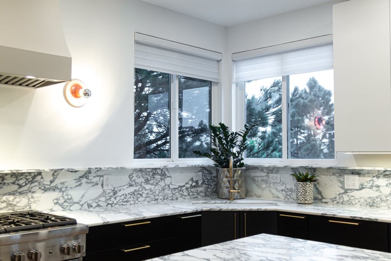 after-kitchen-remodel-with-corner-windows-and-marble-countertops-in-castle-pines