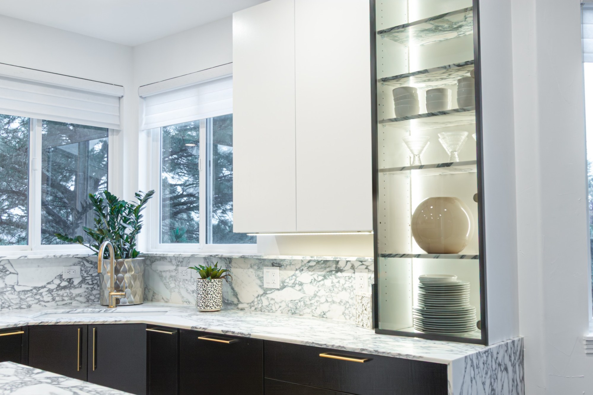 after-kitchen-remodel-with-marble-countertops-and-illuminated-display-shelving-in-castle-pines