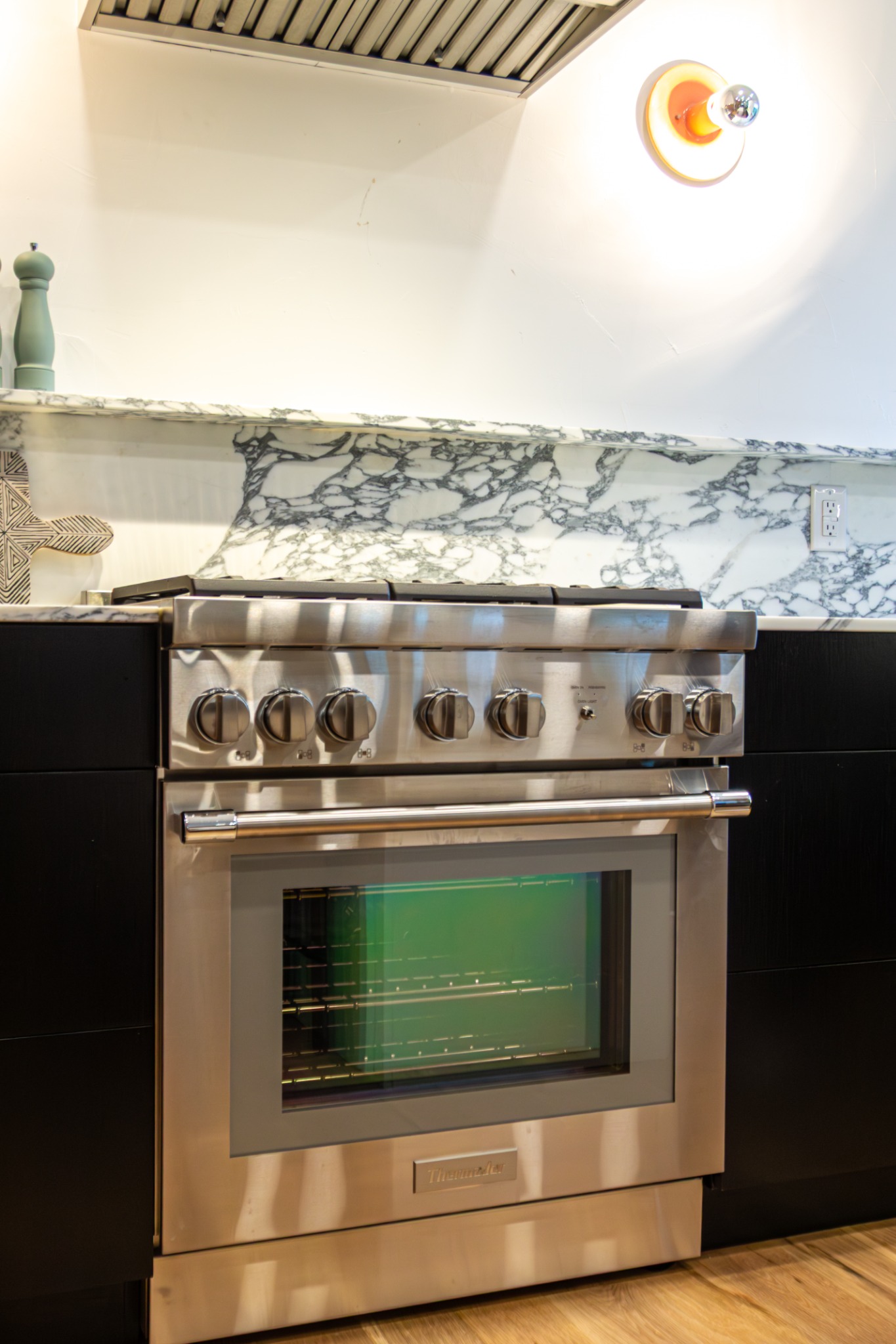 after-kitchen-remodel-with-thermador-gas-range-and-marble-backsplash-in-castle-pines