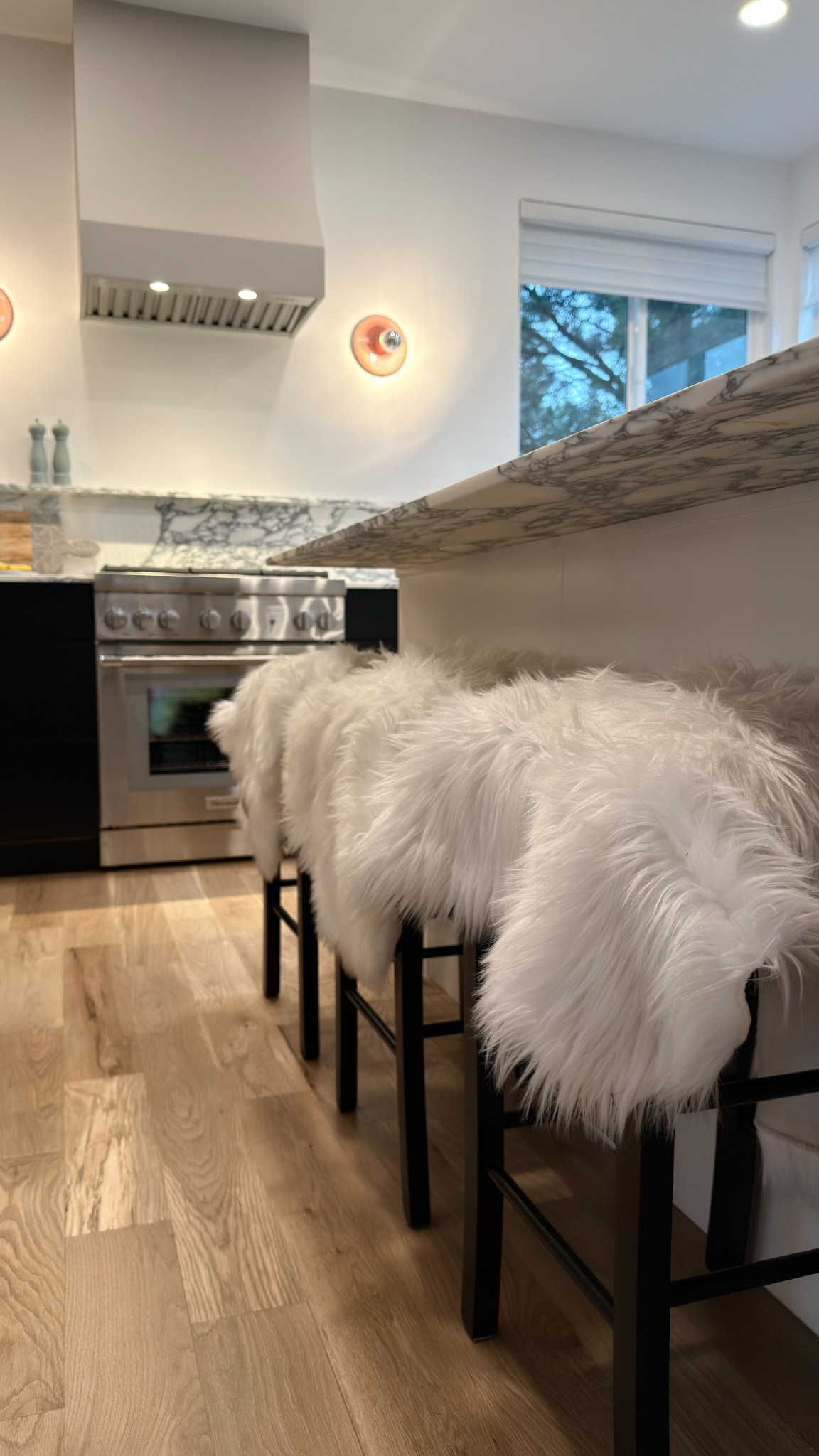 after-kitchen-remodel-with-waterfall-island-and-faux-fur-bar-stools-in-castle-pines