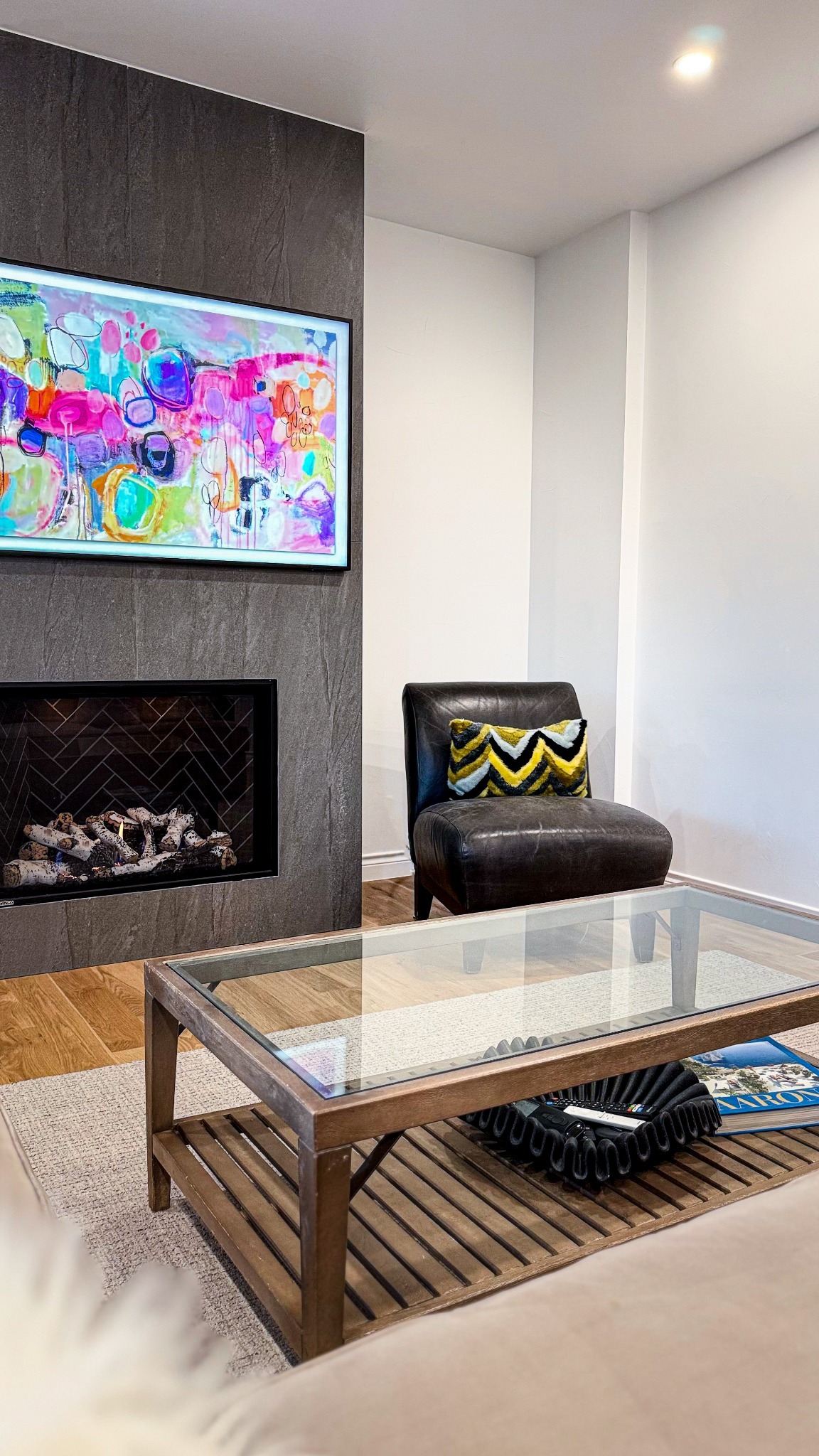 after-living-room-remodel-with-modern-fireplace-and-glass-coffee-table-in-castle-pines