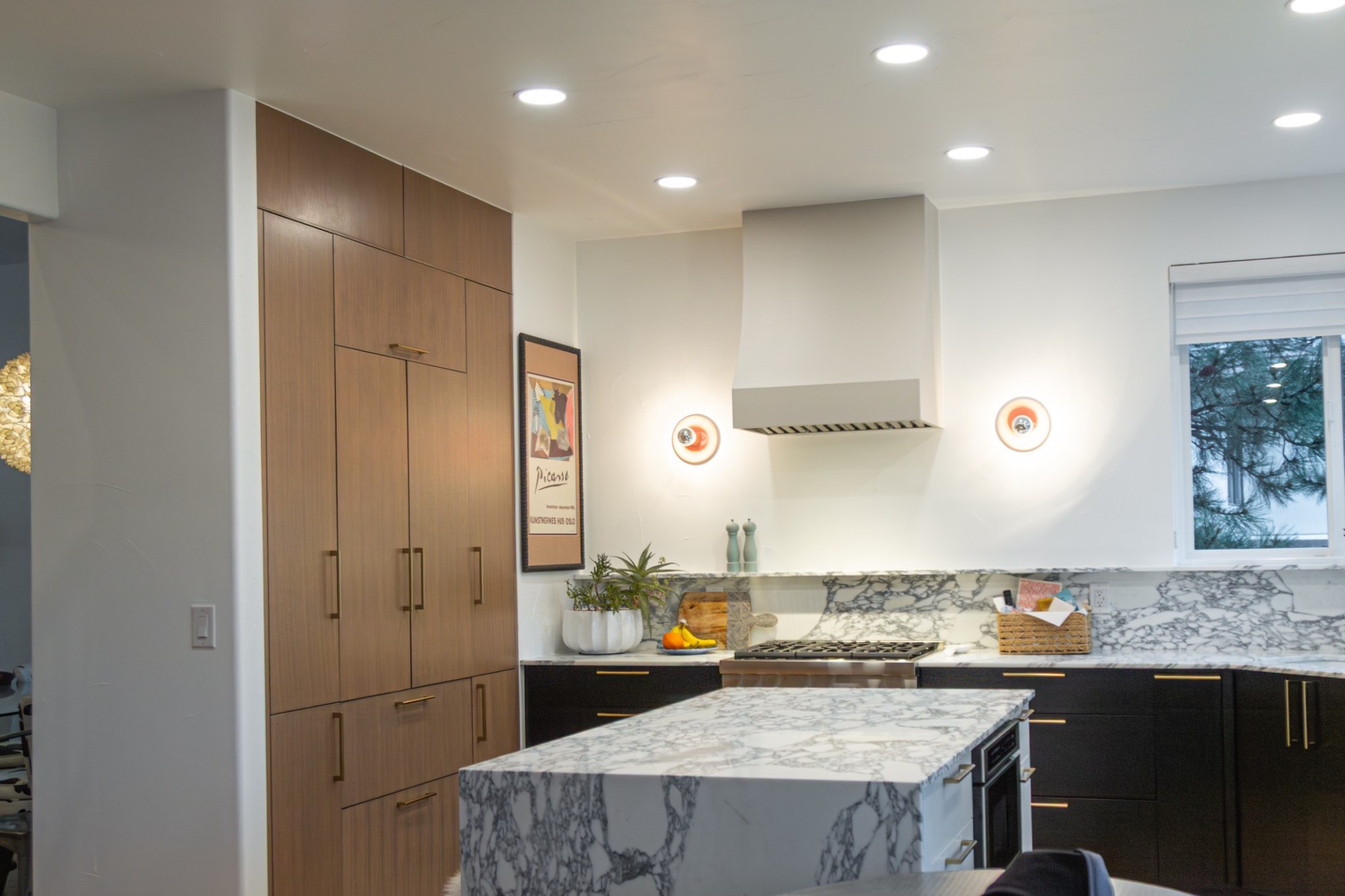 after-modern-kitchen-remodel-with-walnut-pantry-wall-and-marble-island-in-castle-pines