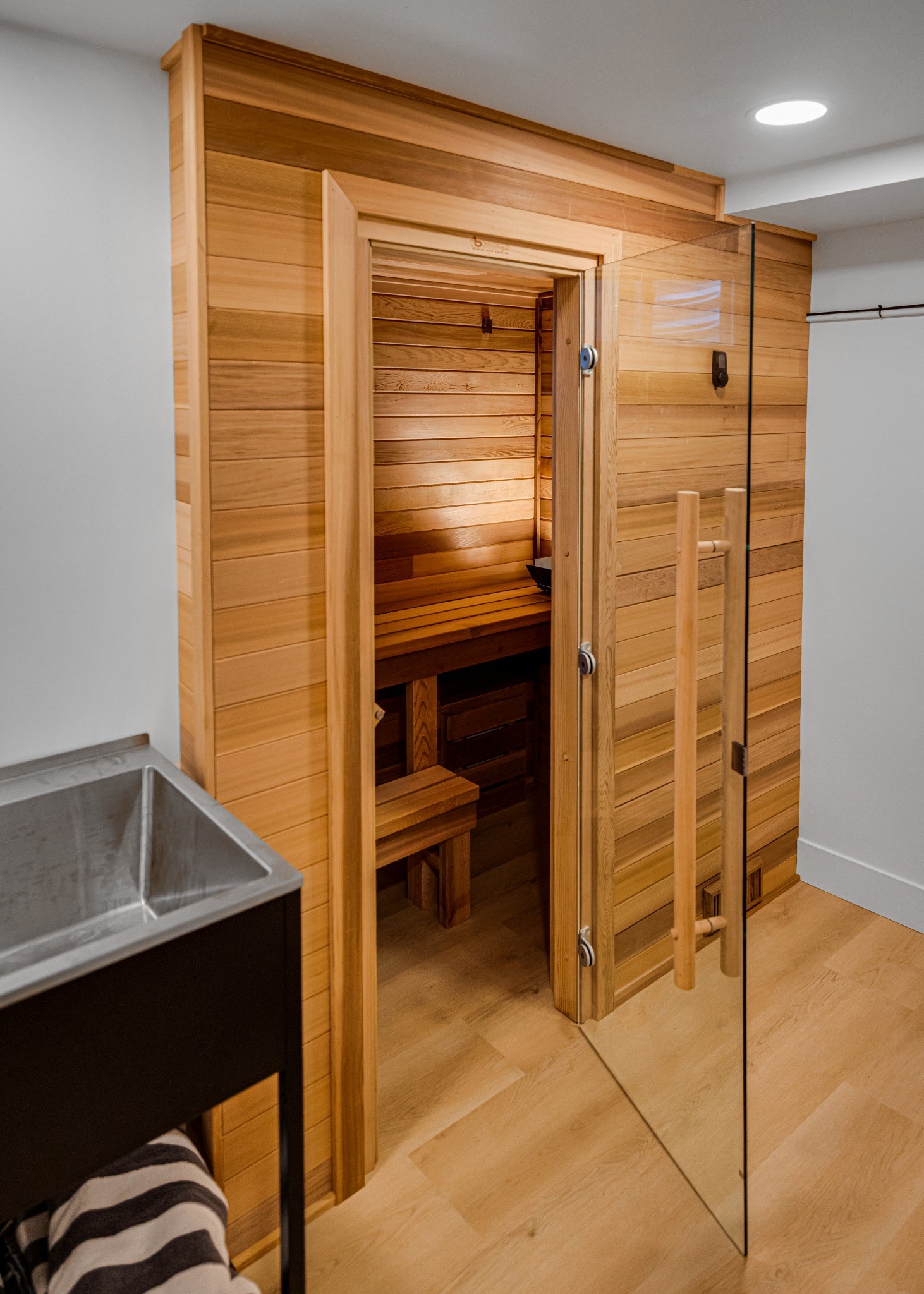 after-denver-whole-home-remodel-cedar-sauna-with-glass-door-entry