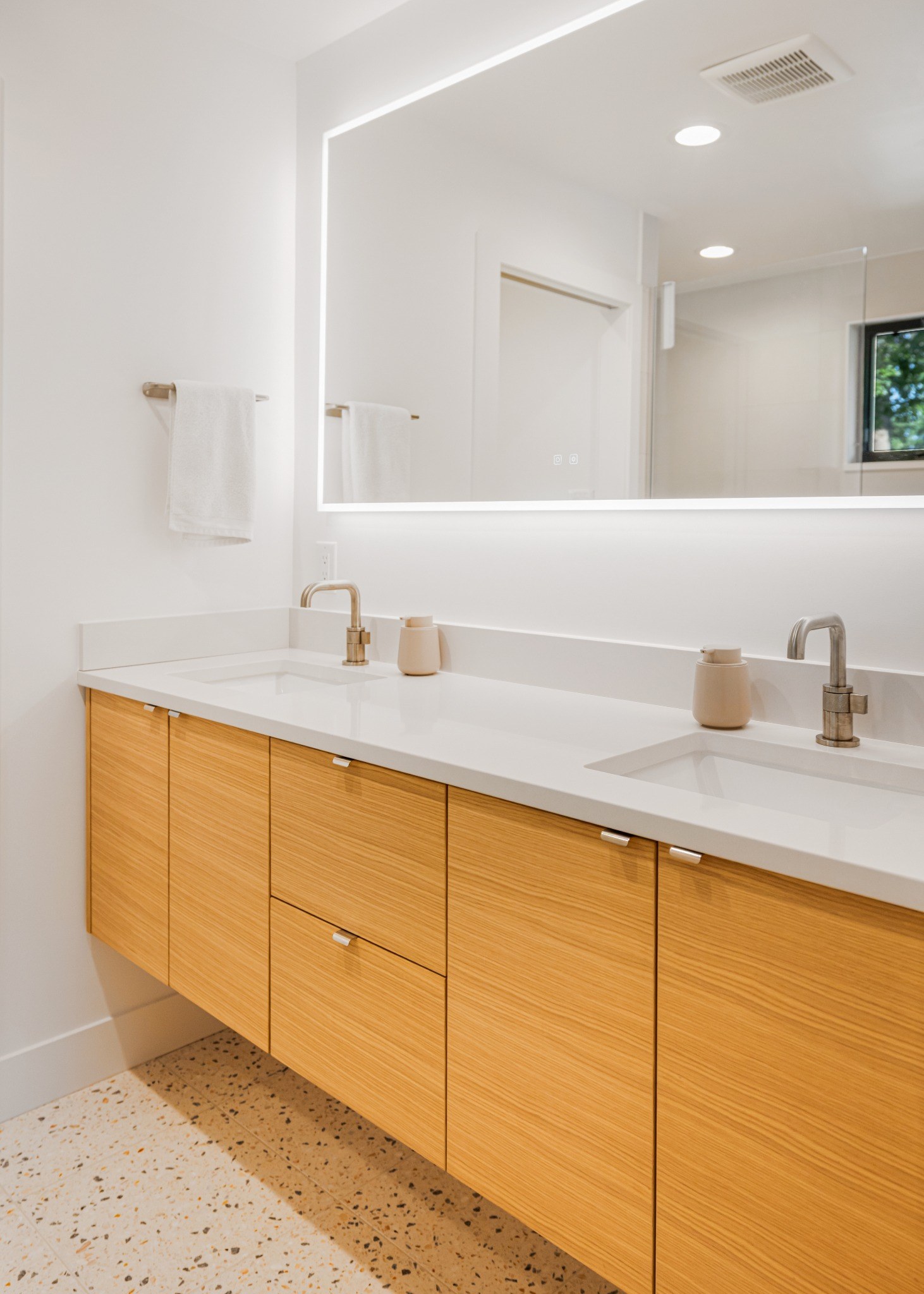 after-denver-whole-home-remodel-floating-wood-bathroom-vanity-with-backlit-mirror