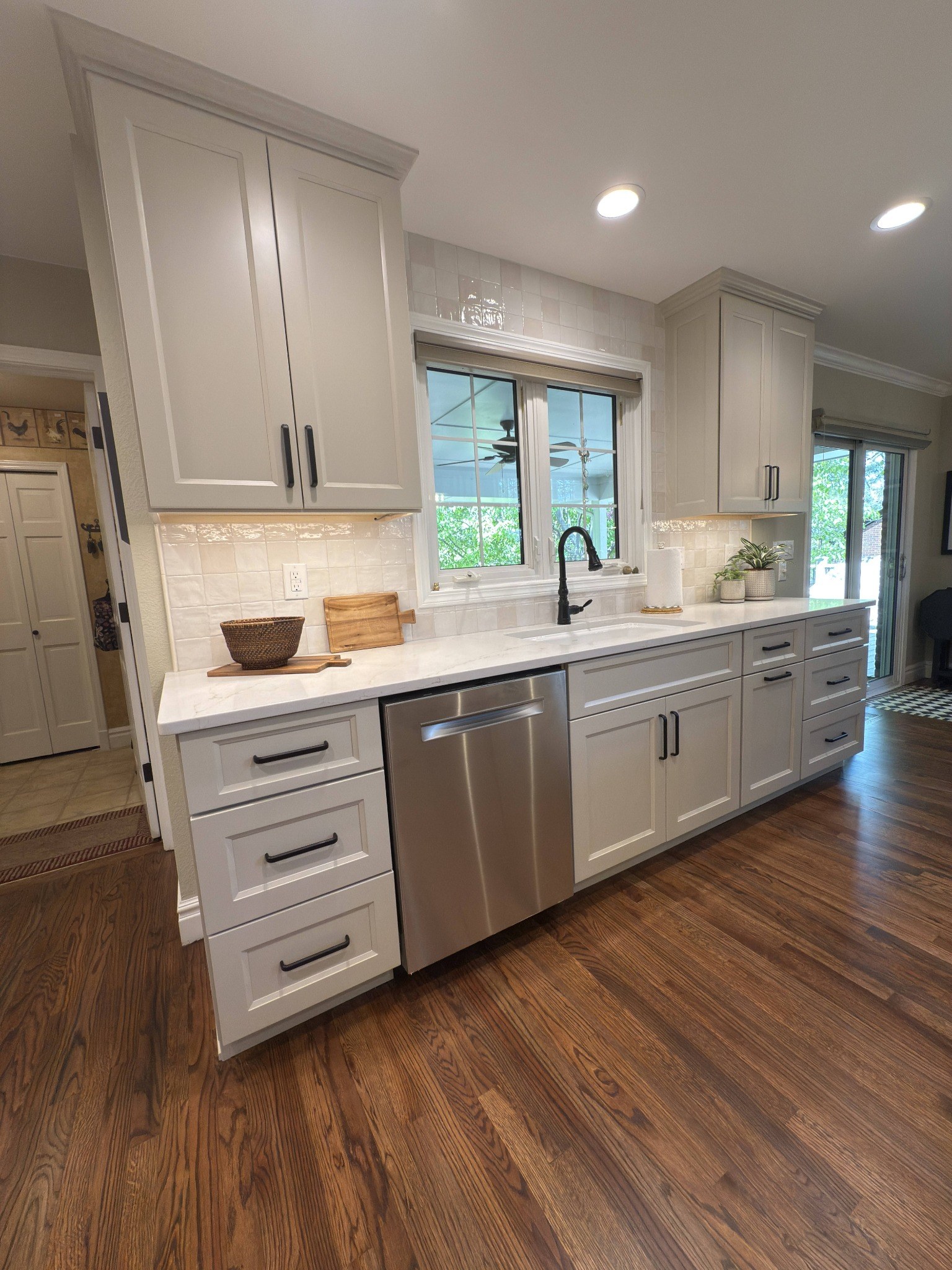 after-littleton-kitchen-remodel-open-kitchen-with-white-cabinets-and-hardwood-floors