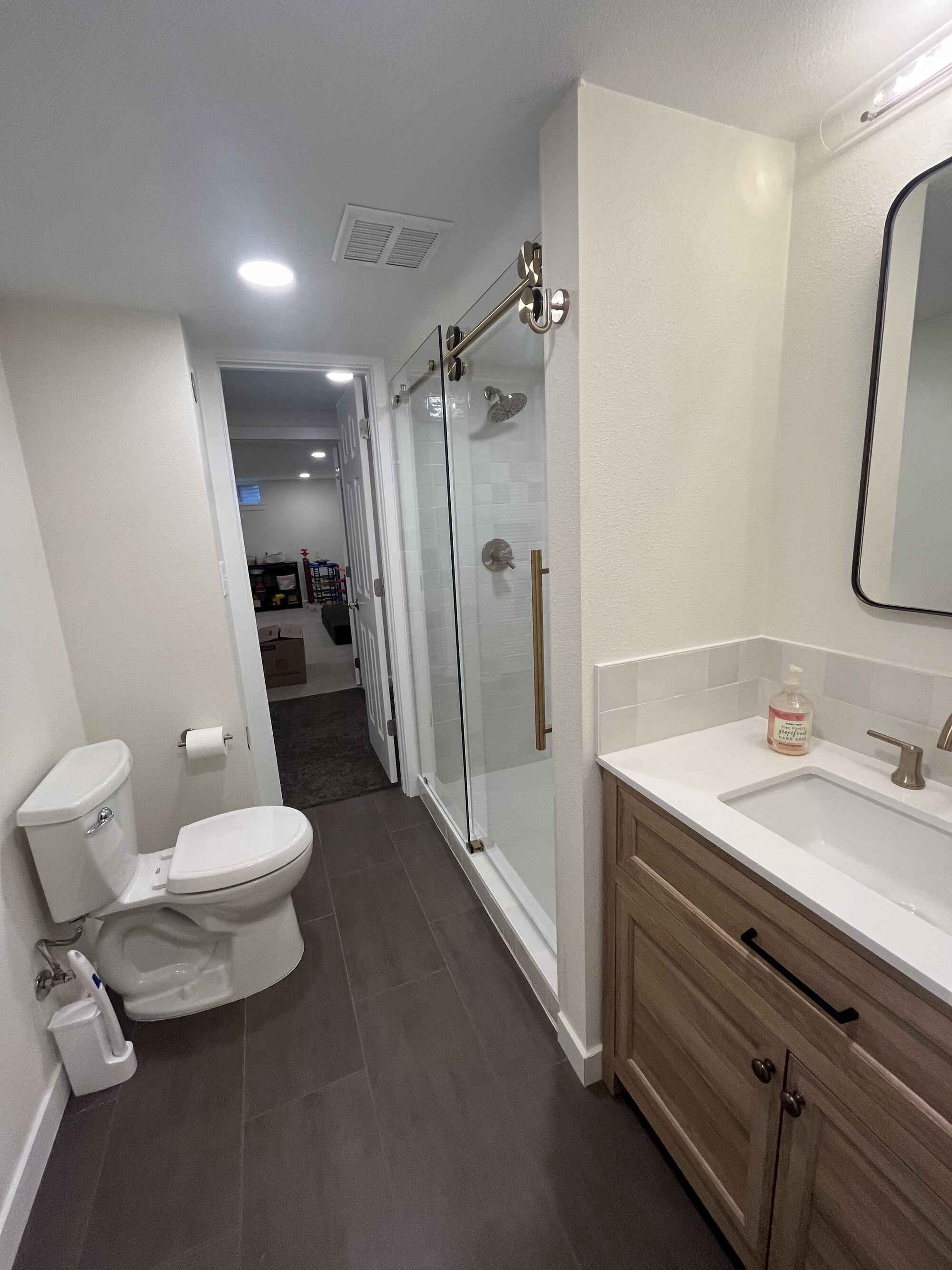 Unique-small-floor-plan-bathroom-basement-white-tile-wood-vanity-Littleton-Colorado2