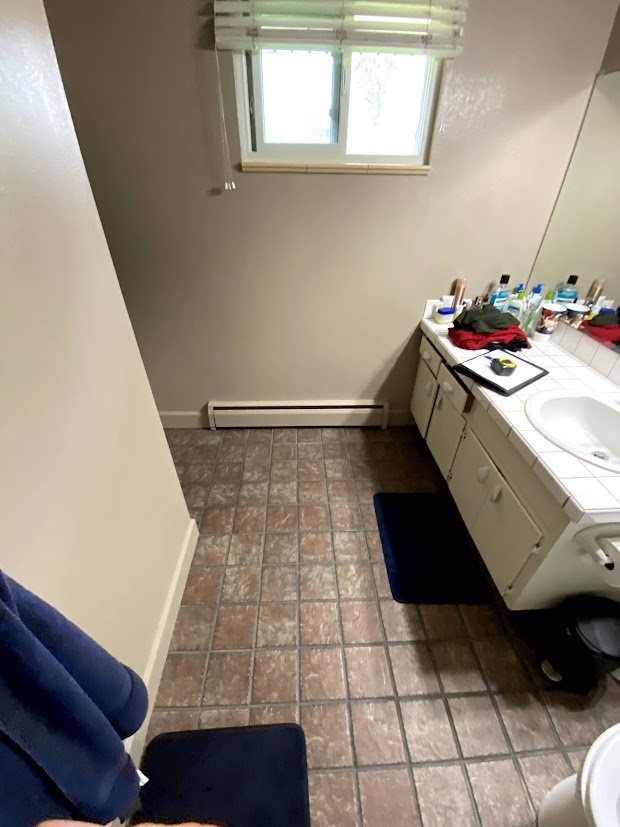 before-littleton-whole-home-remodel-outdated-bathroom-with-tile-flooring-and-single-vanity