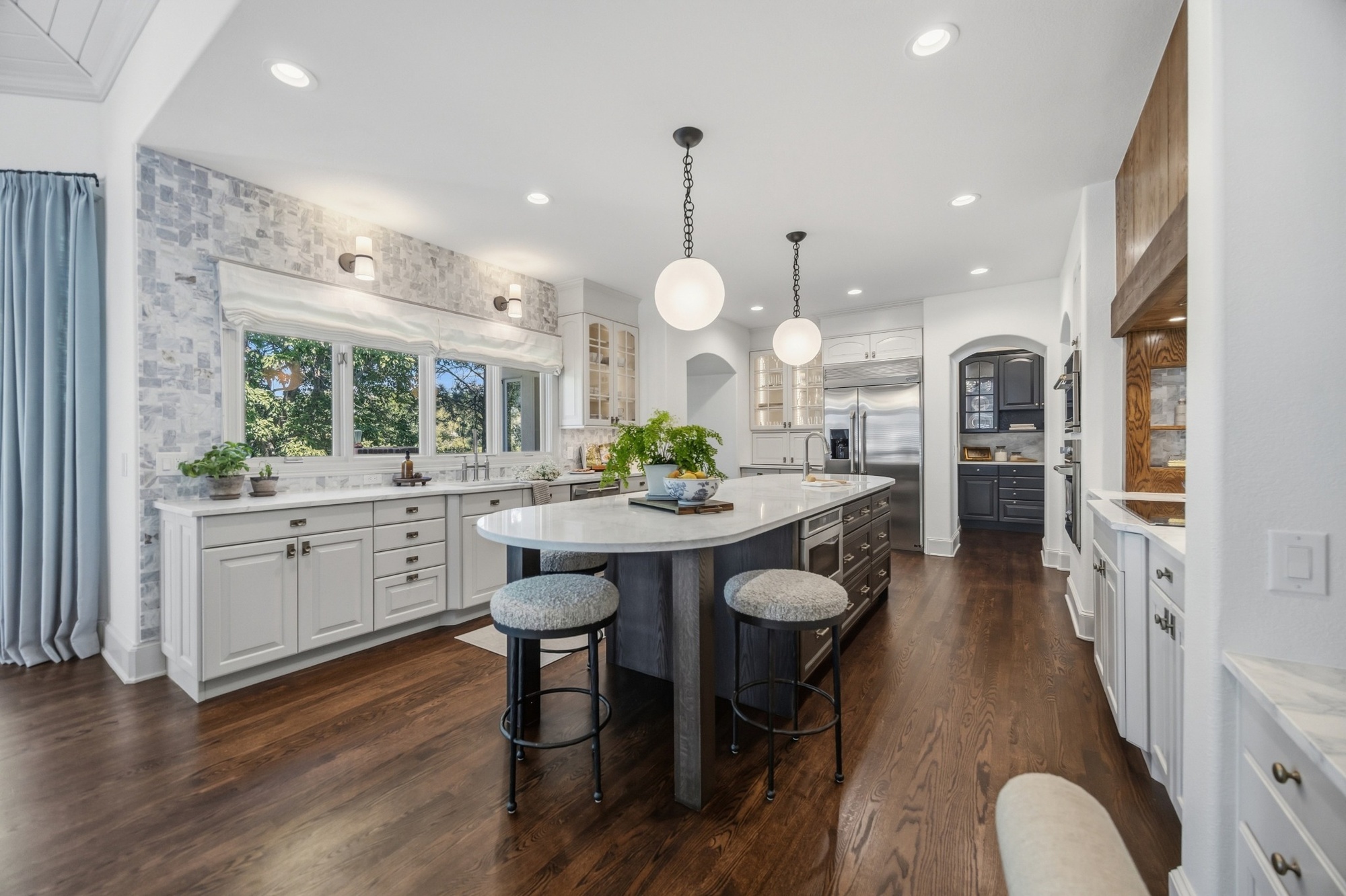 remodeled kitchen with white cabinetry island and stainless steel appliances in greenwood village co whole home remodel