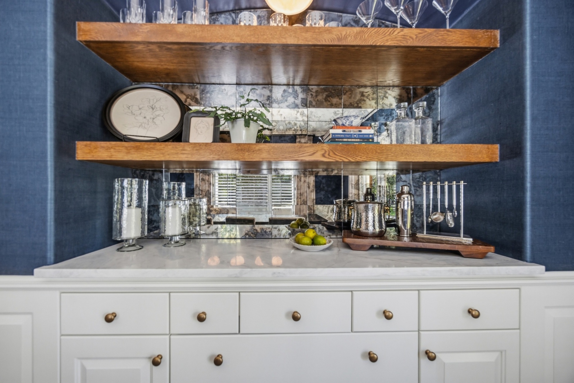 whole home remodel built in dining room bar with wood shelves and mirrored backsplash in greenwood village co