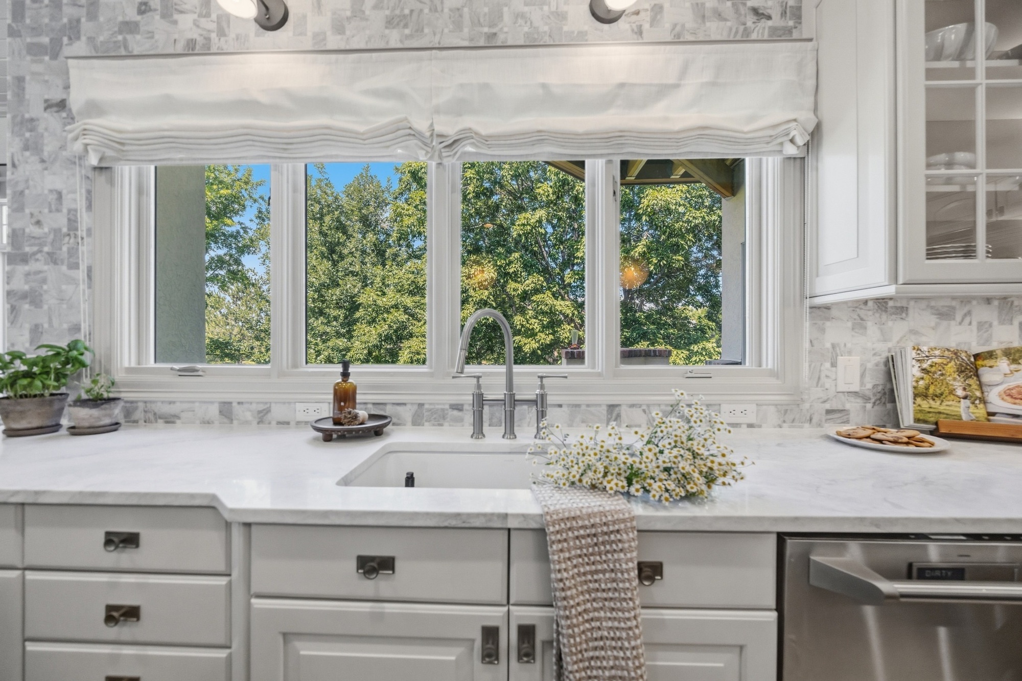 whole home remodel kitchen sink with marble counters and large windows in greenwood village co