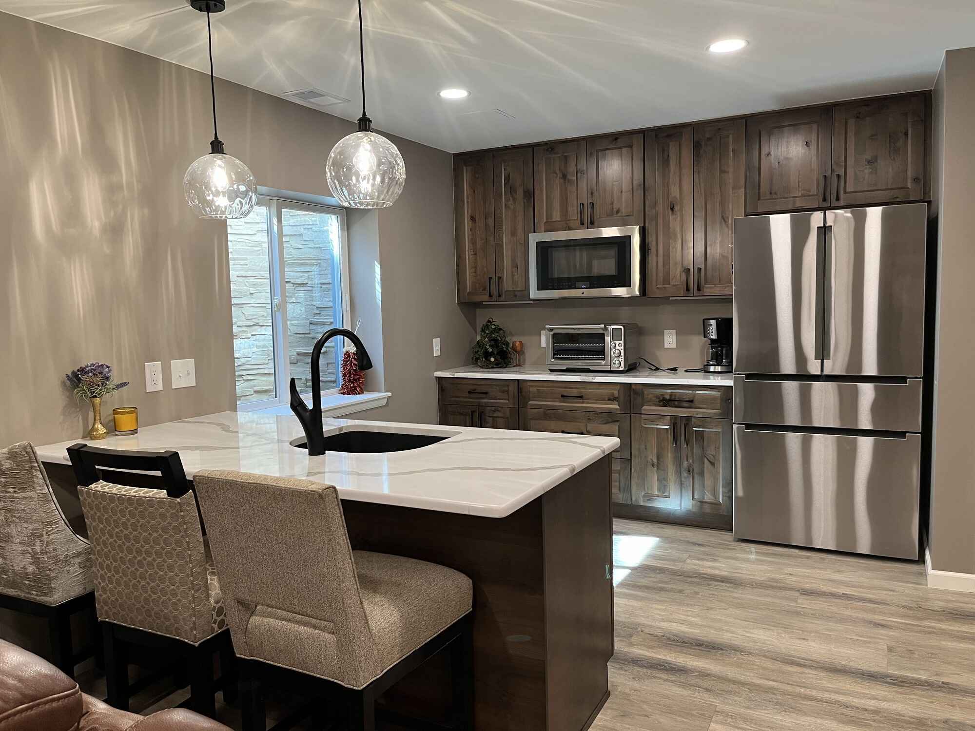 Beautiful-open-basement-kitchen-brown-cabinets-quartz-countertops-Littleton-Colorado4-1