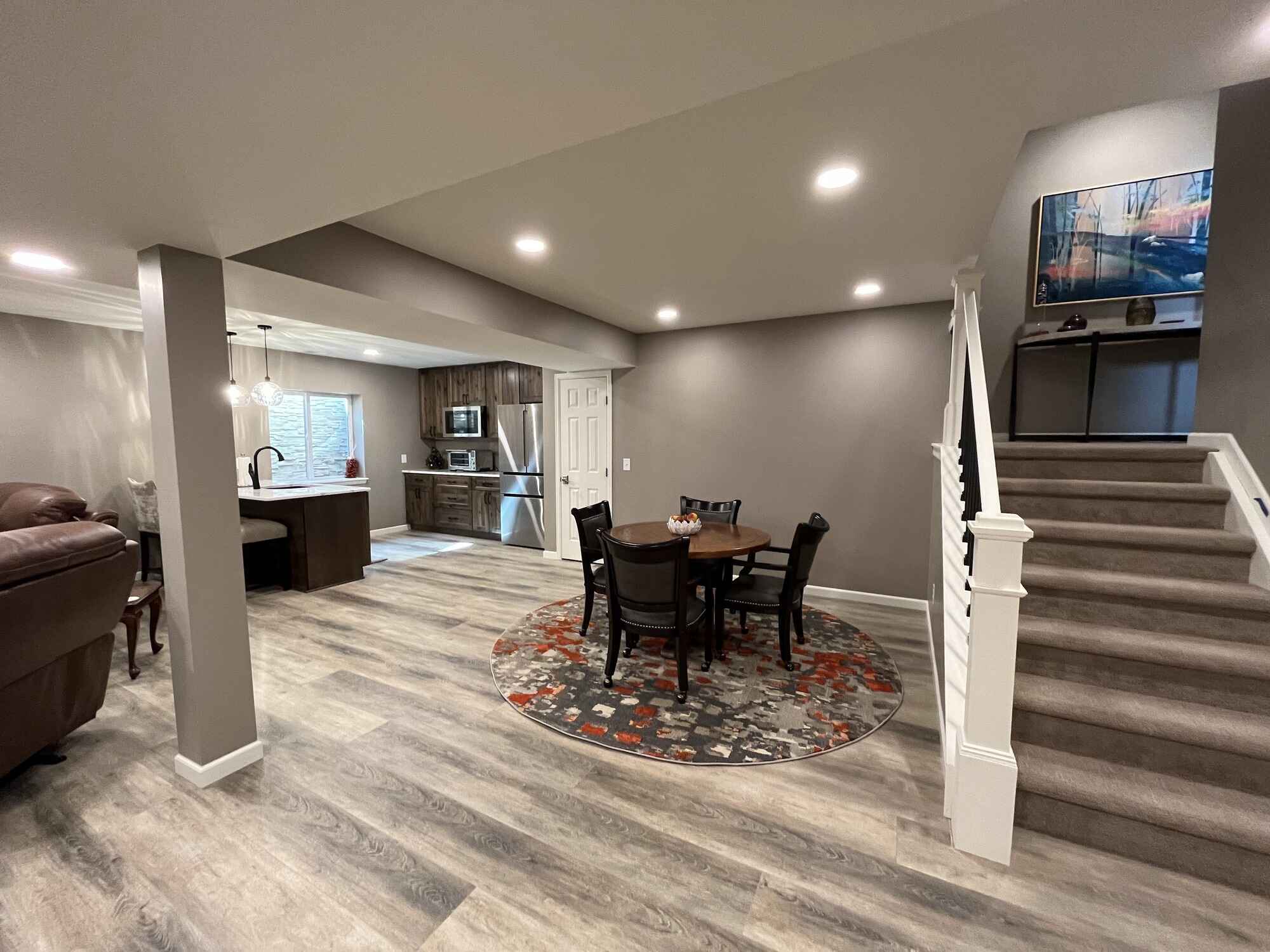 Beautiful-open-basement-kitchen-brown-cabinets-quartz-countertops-Littleton-Colorado