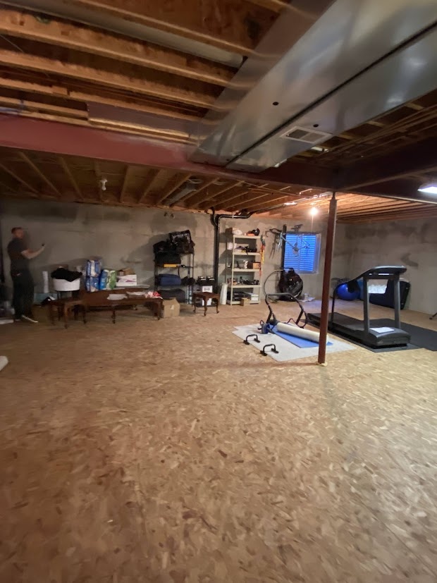 before highlands ranch basement remodel large unfinished basement with steel support beams and exposed mechanical systems