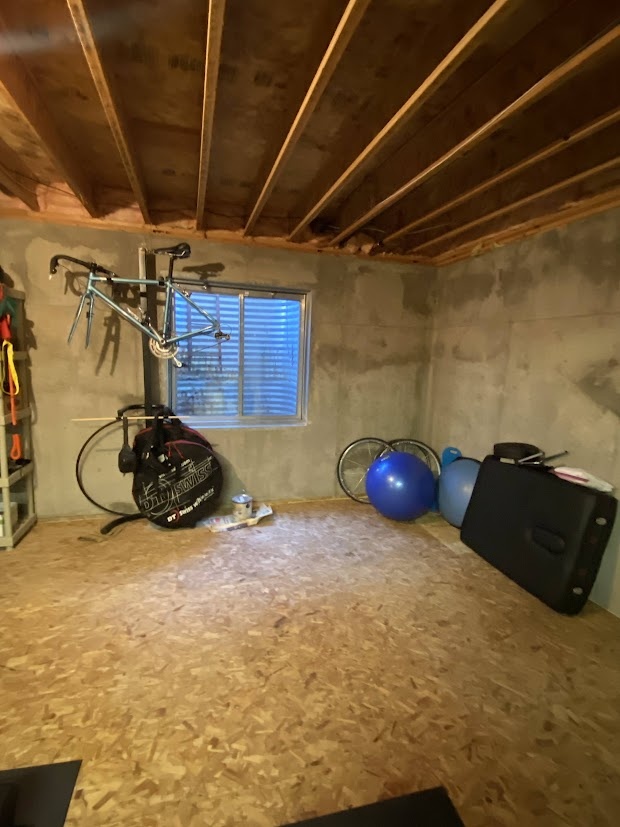 before highlands ranch basement remodel unfinished basement corner with storage shelves and exposed concrete walls