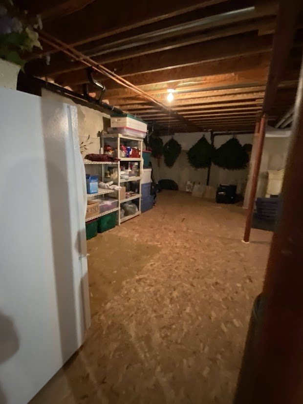 before highlands ranch basement remodel unfinished storage area with exposed concrete walls and hanging bicycle