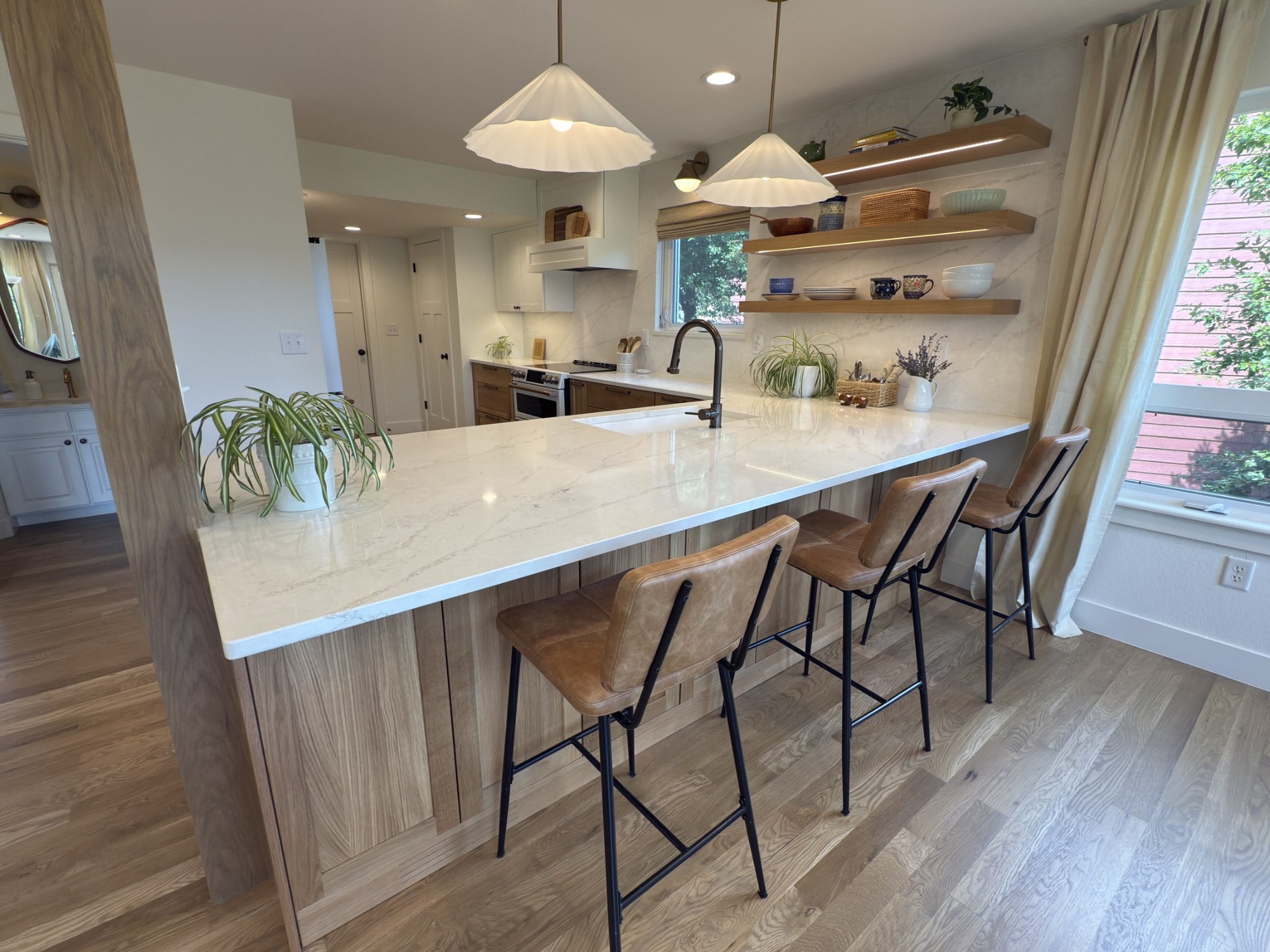 after-littleton-kitchen-remodel-peninsula-bar-stools-and-shelf-wall