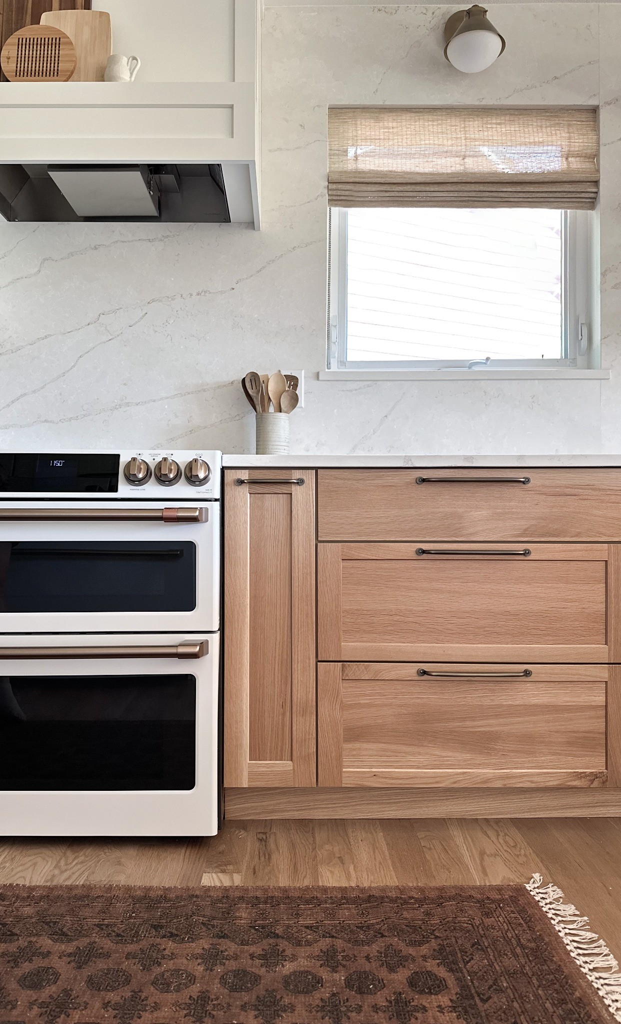 after-littleton-kitchen-remodel-range-and-window-with-wood-drawer-cabinets
