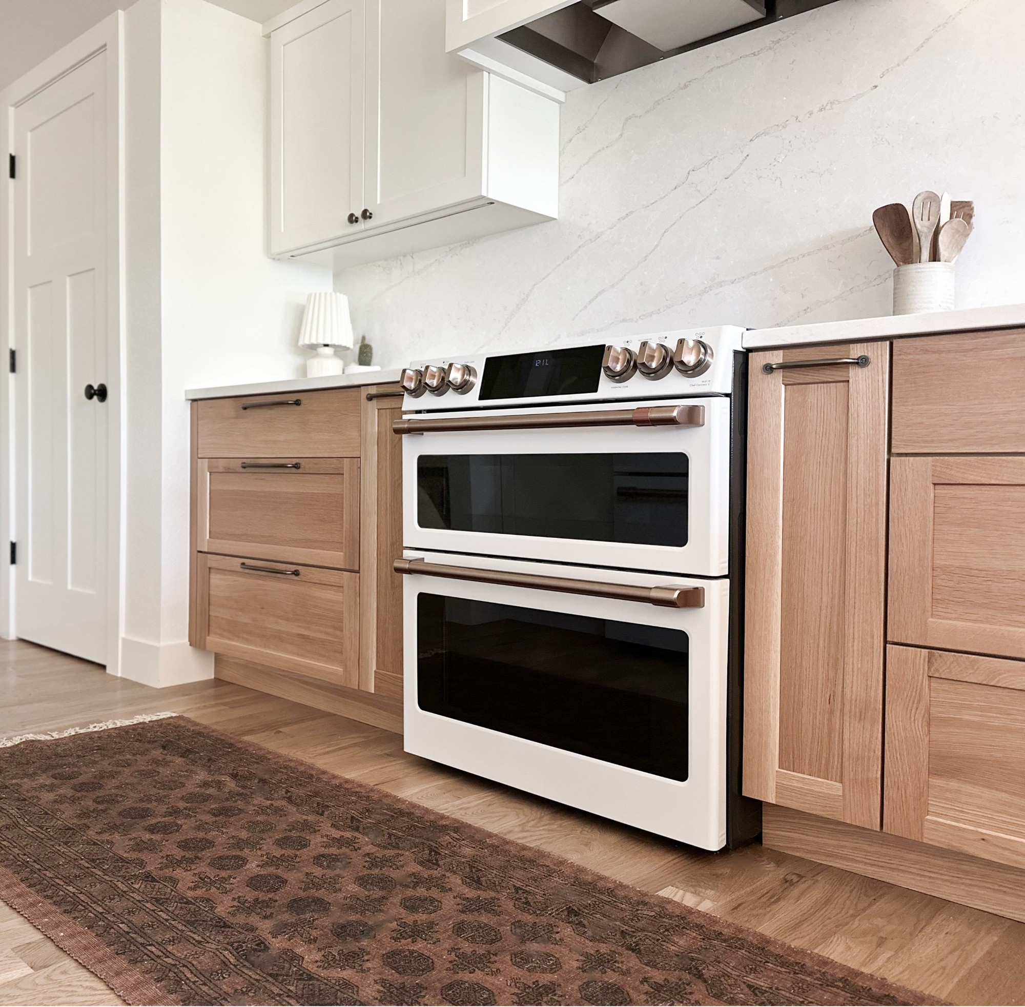 after-littleton-kitchen-remodel-white-range-low-angle-with-wood-cabinets