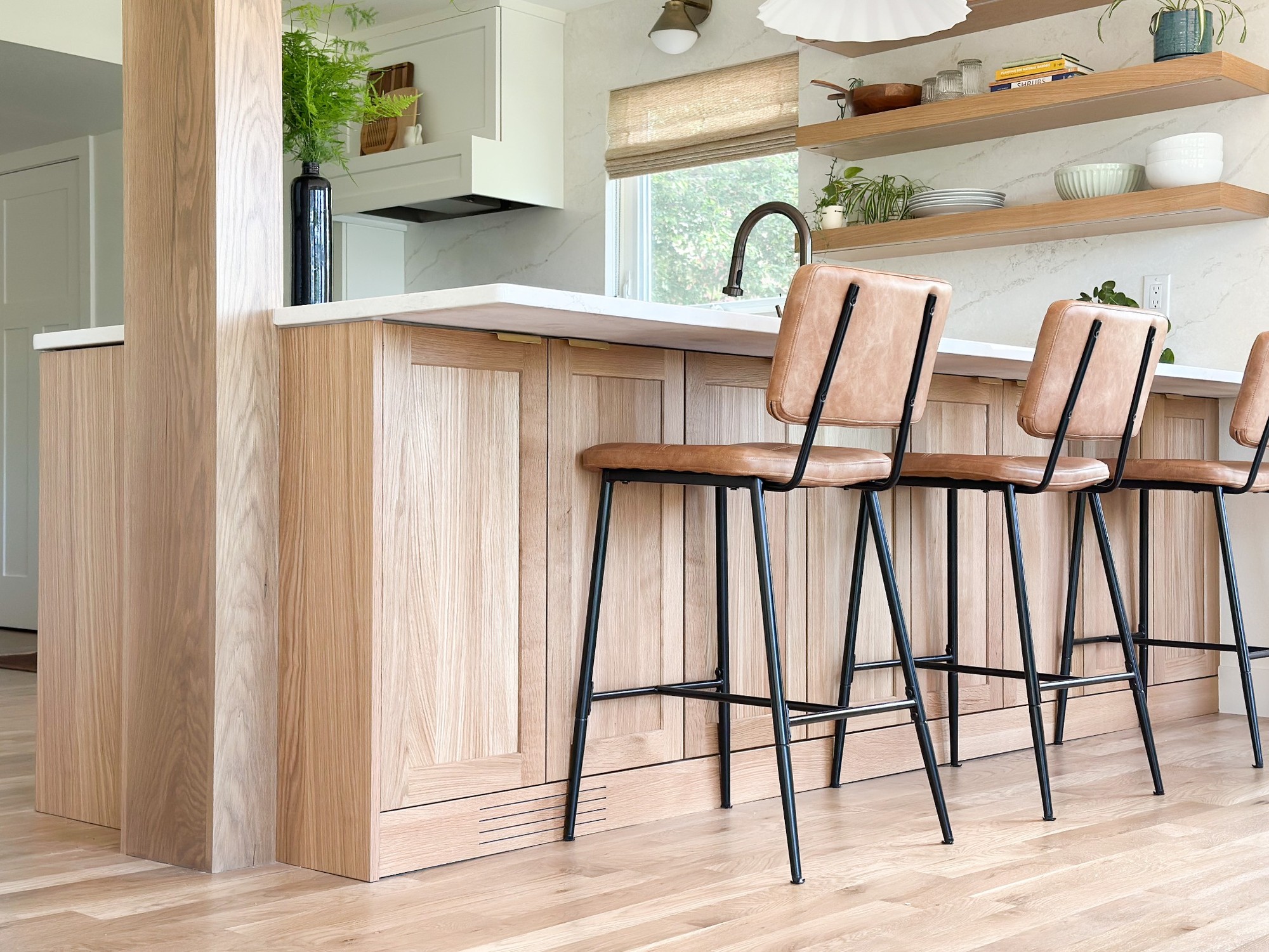 After-littleton-kitchen-remodel-wood-peninsula-paneling-with-bar-stools