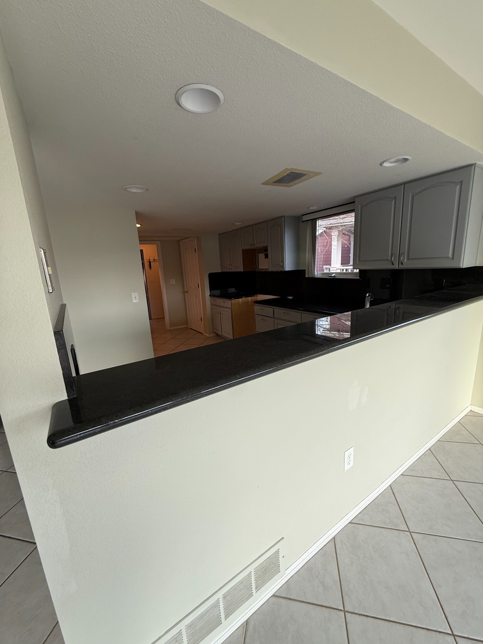 before-littleton-kitchen-remodel-raised-pass-through-wall-with-black-counter