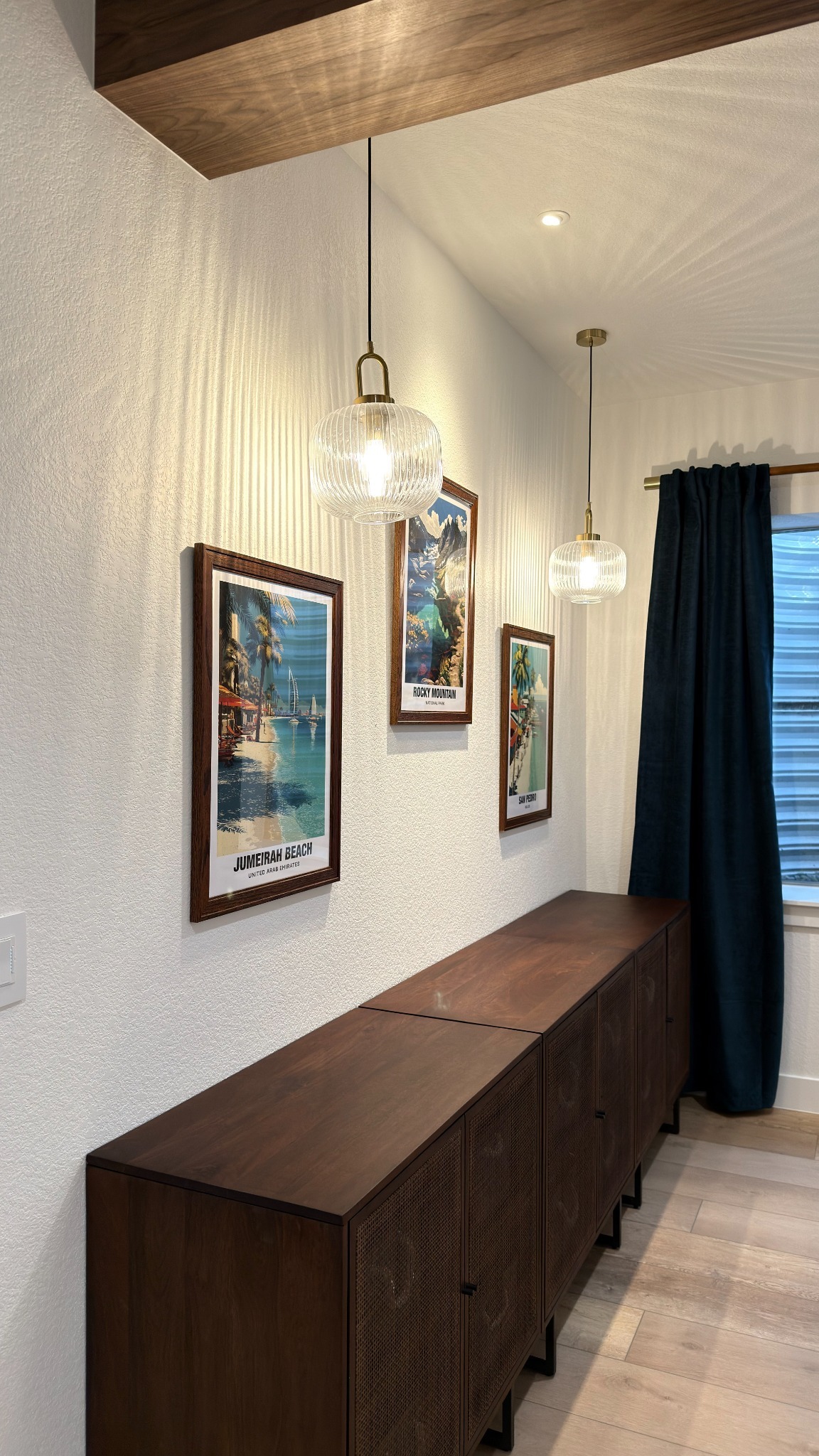 modern sideboard with pendant lighting and artwork in golden basement remodel