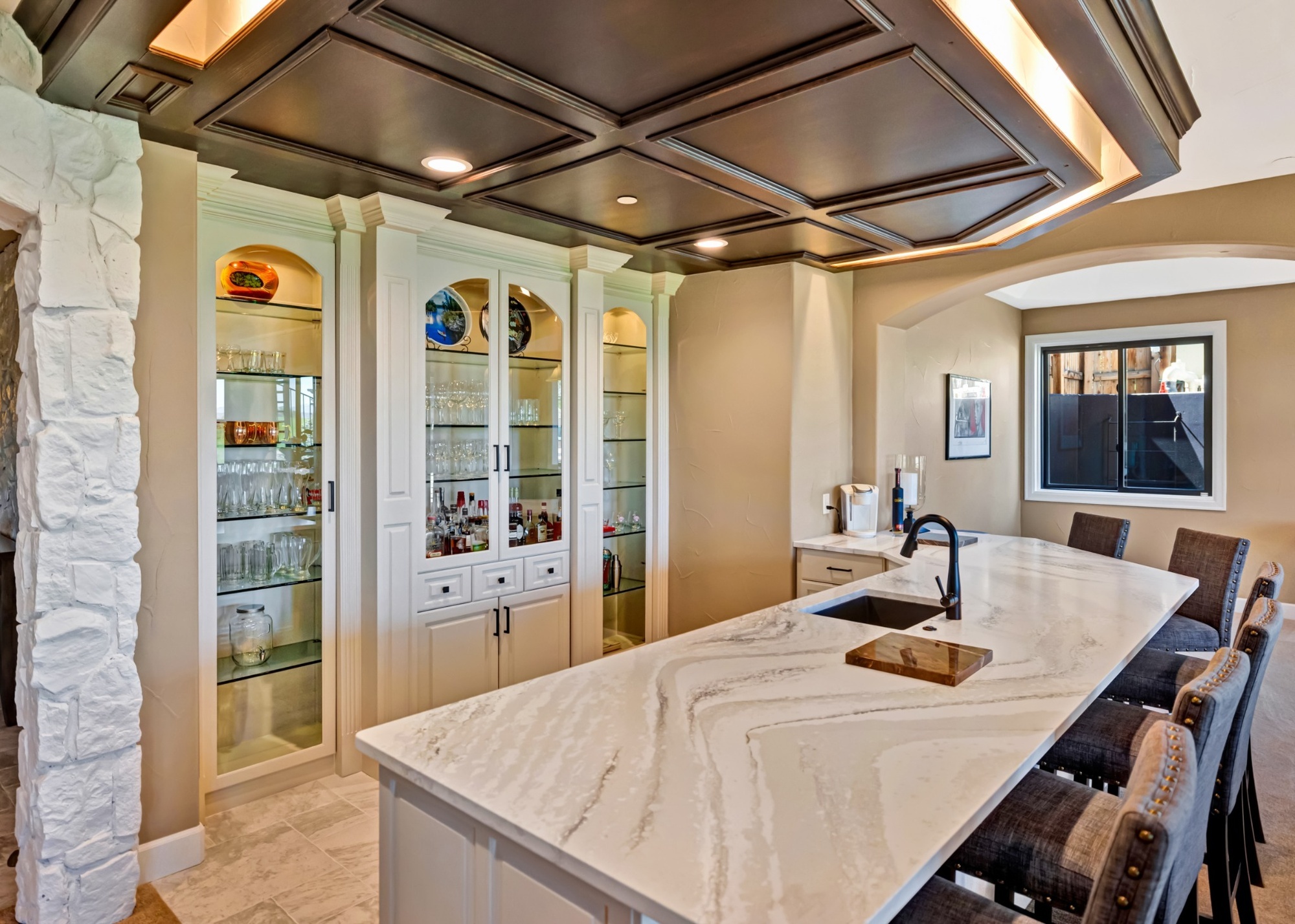 after castle pines whole home remodel basement wet bar with coffered ceiling and marble countertop