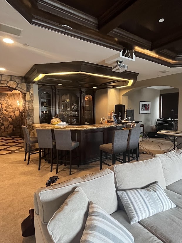 before castle pines whole home remodel basement bar with dark coffered ceiling and seating