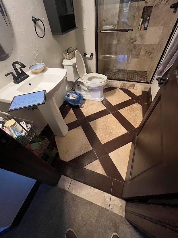 before castle pines whole home remodel bathroom with pedestal sink and patterned tile floor