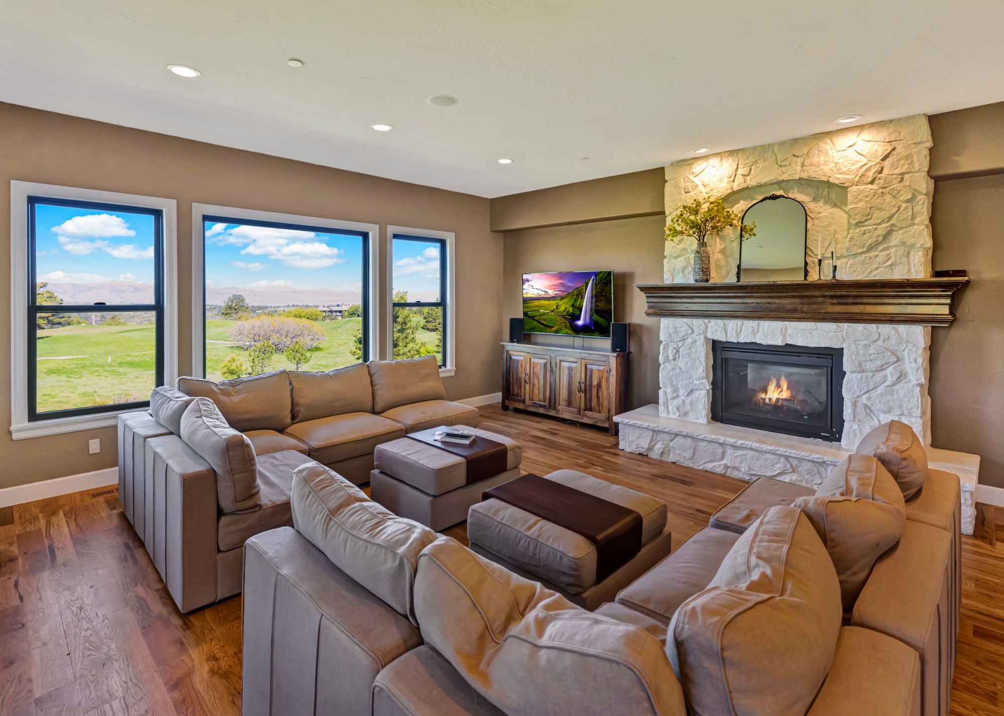 whole home remodel, living room with stone fireplace and expansive windows